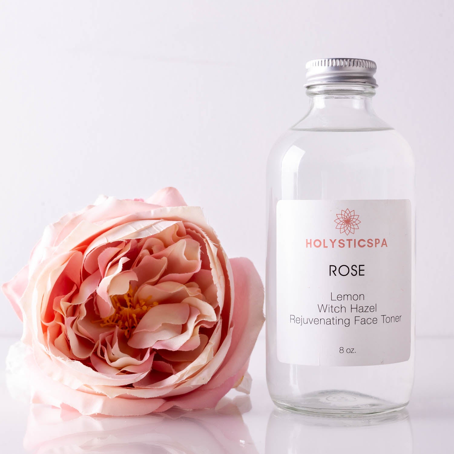 A bottle of Rose Rejuvenating Face Toner with a floral design, showcasing its natural ingredients and hydrating properties.