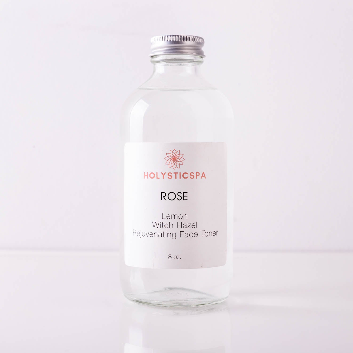 A bottle of Rose Rejuvenating Face Toner with a floral design, showcasing its natural ingredients and hydrating properties.