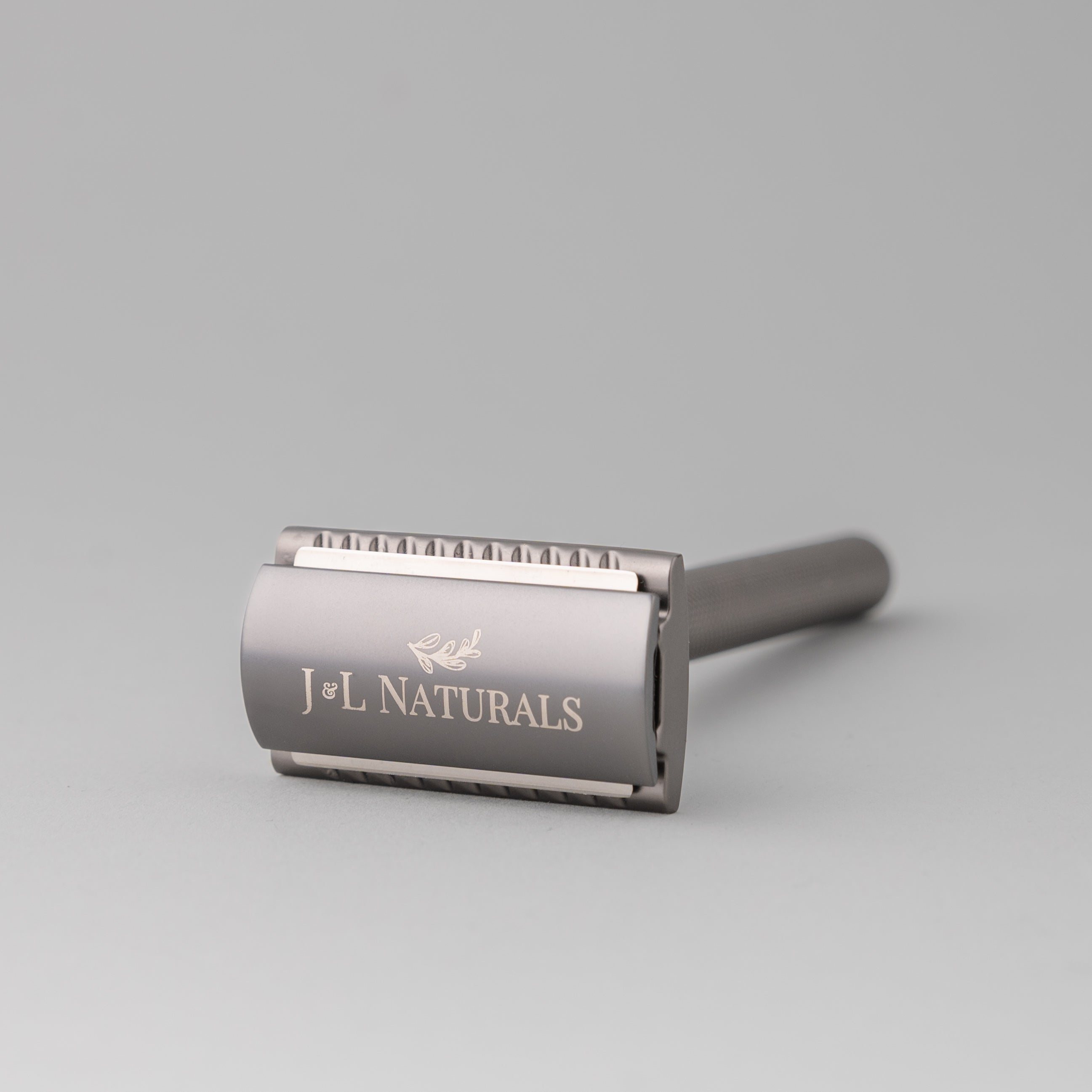 A sleek stainless steel safety razor with five refill blades, available in Black, Rose Gold, Green, and White, showcasing its ergonomic design.