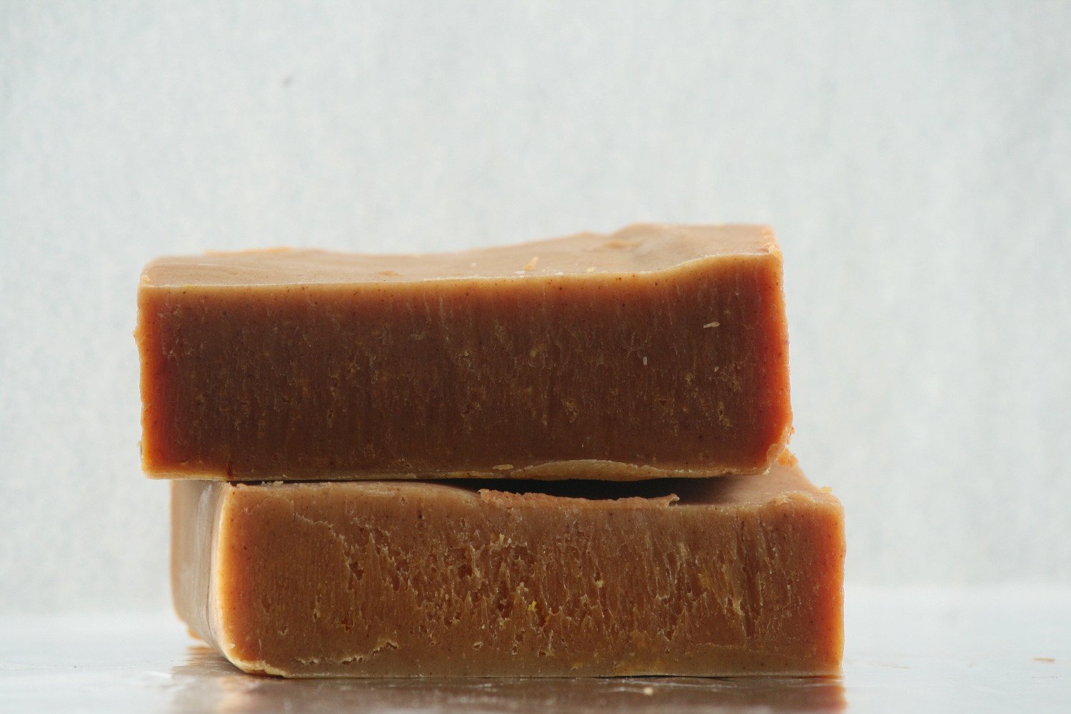 Sandalwood Turmeric Soap Bar with natural ingredients, showcasing its rich texture and earthy color.