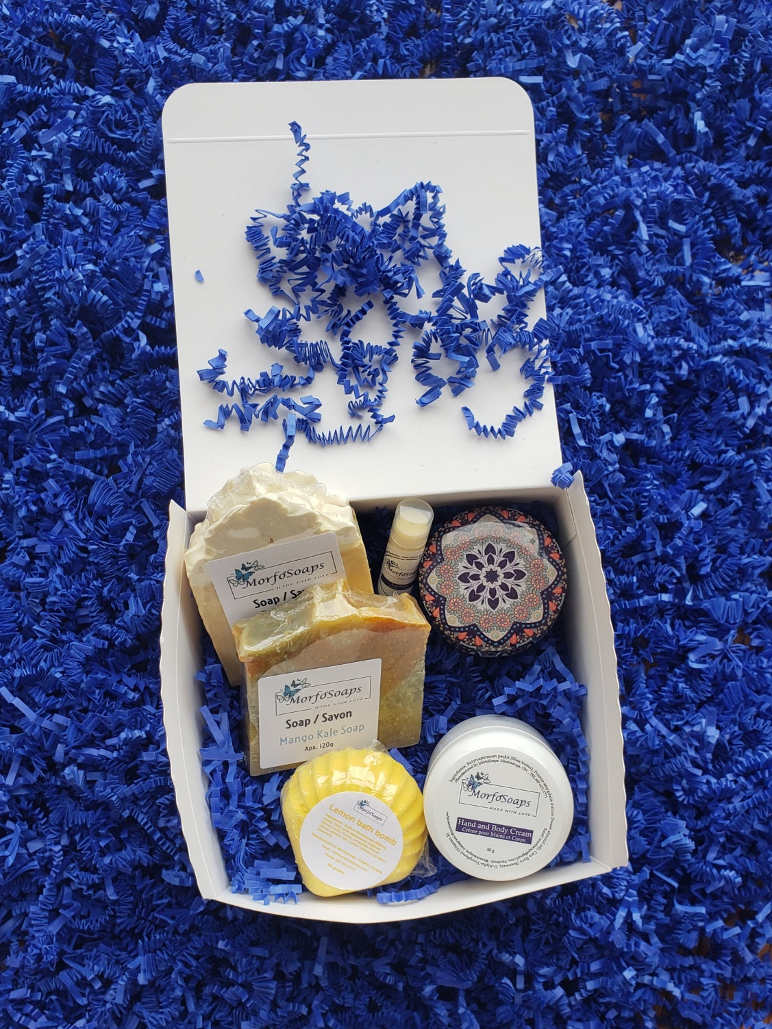 Self-Care Gift Box by Morfosoaps featuring artisan soaps, bath bomb, hand cream, and lip balm, beautifully packaged for gifting.