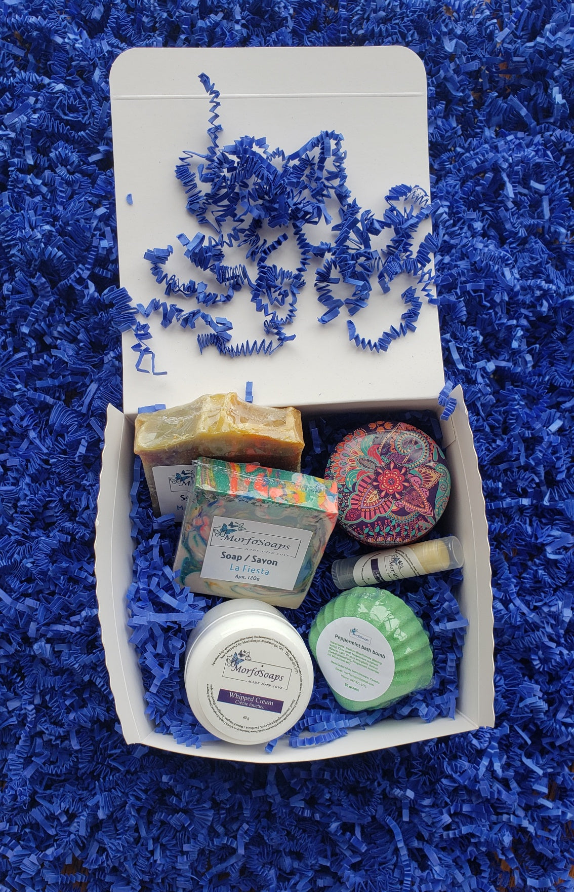 Self-Care Gift Box by Morfosoaps featuring artisan soaps, bath bomb, hand cream, and lip balm, beautifully packaged for gifting.