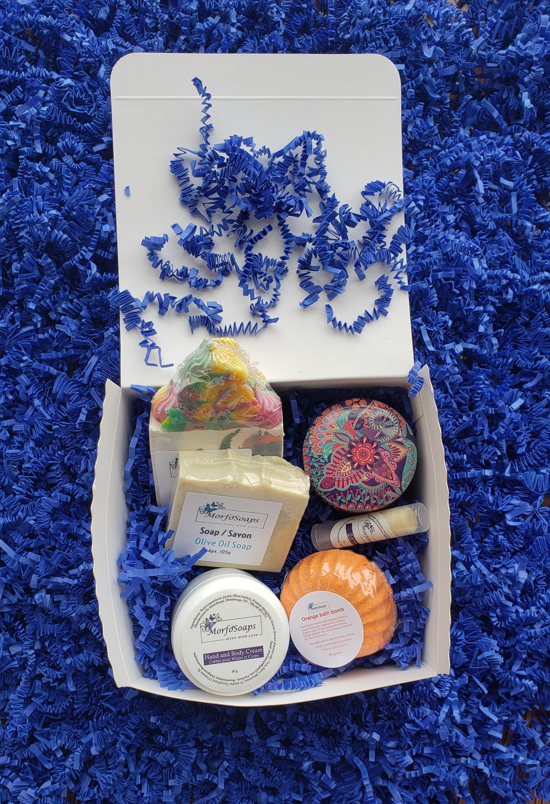 Self-Care Gift Box by Morfosoaps featuring artisan soaps, bath bomb, hand cream, and lip balm, beautifully packaged for gifting.