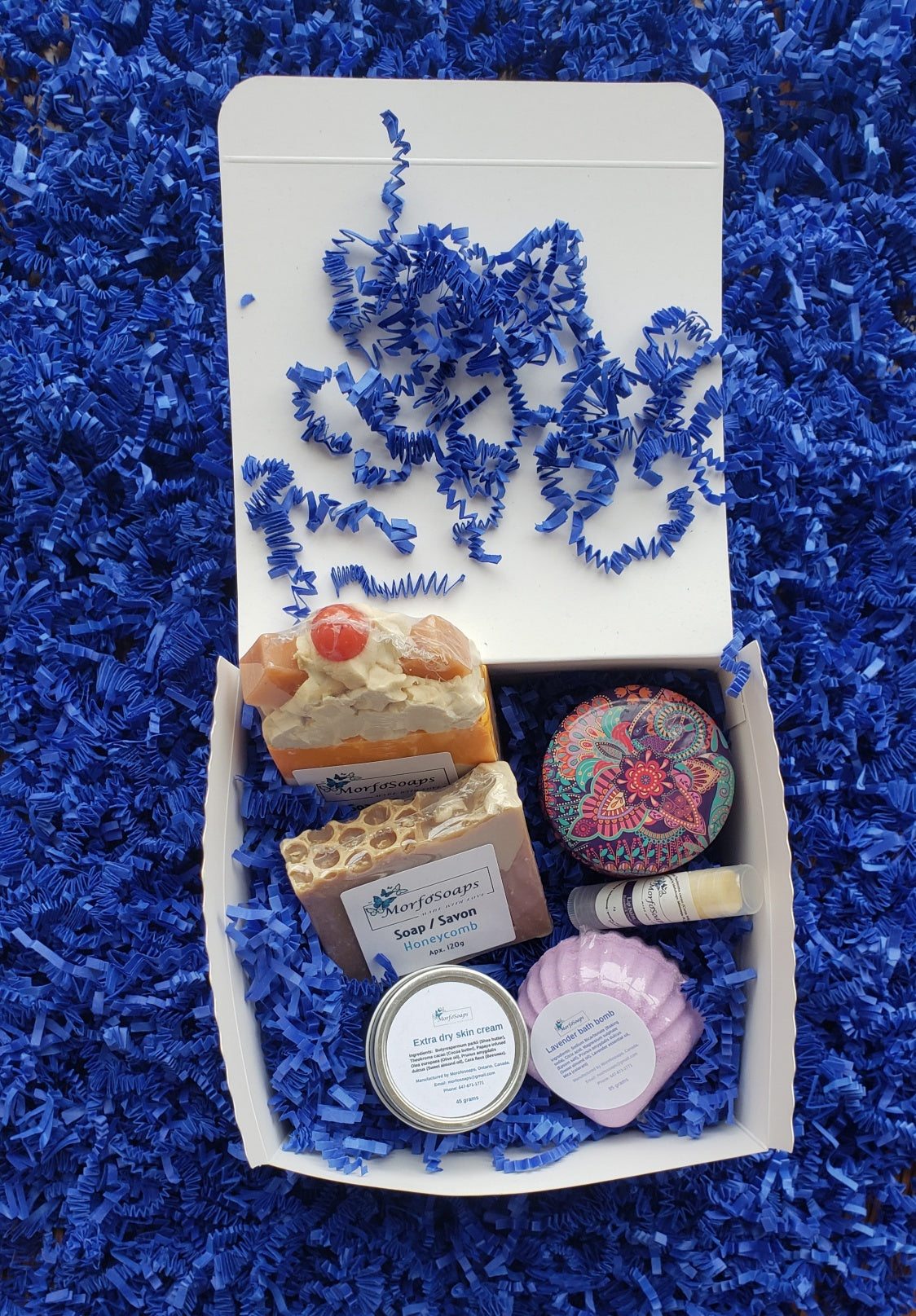 Self-Care Gift Box by Morfosoaps featuring artisan soaps, bath bomb, hand cream, and lip balm, beautifully packaged for gifting.