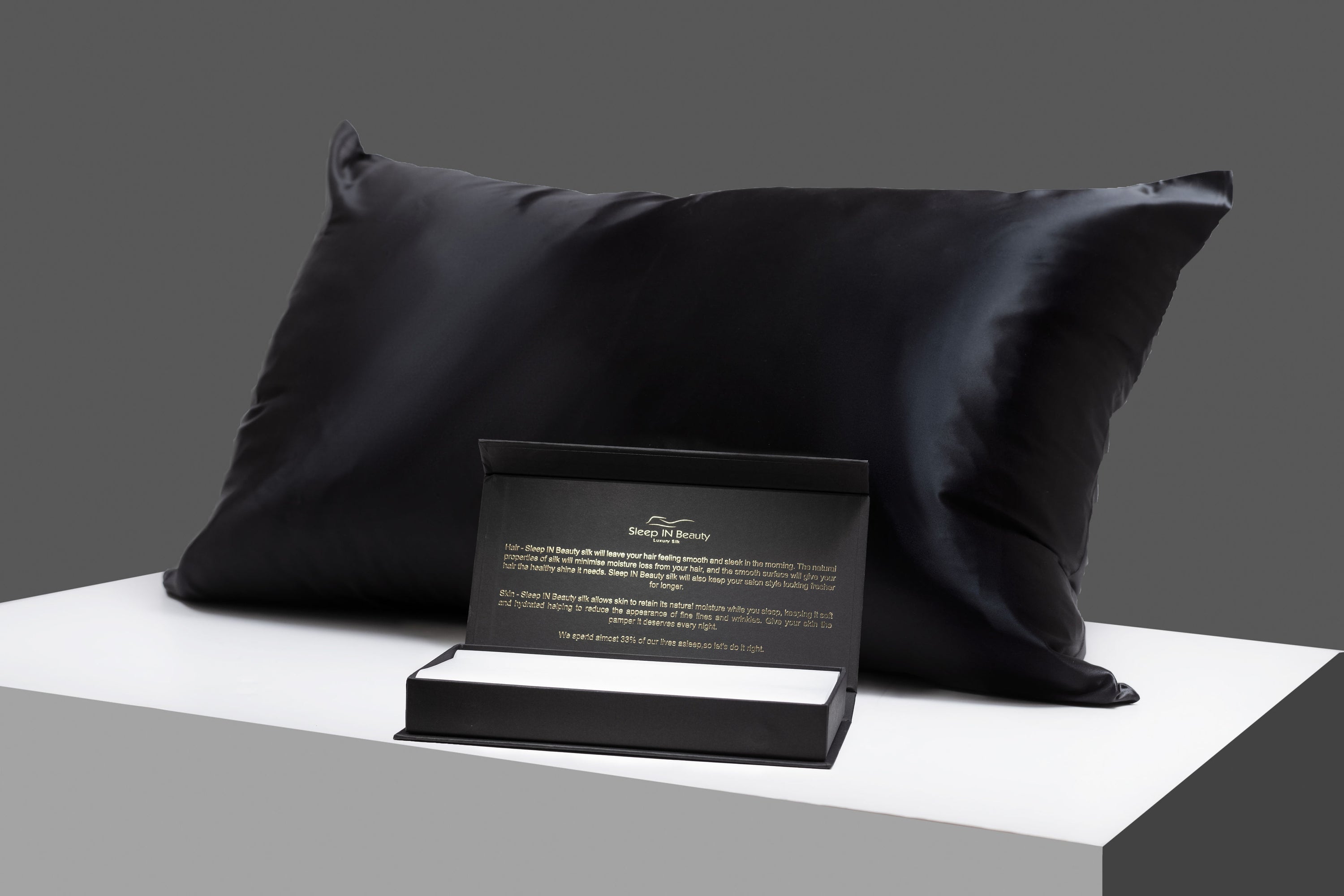 SIB™ Silk Pillowcase in luxurious black silk with hidden zipper, elegantly presented in a gold gift box.