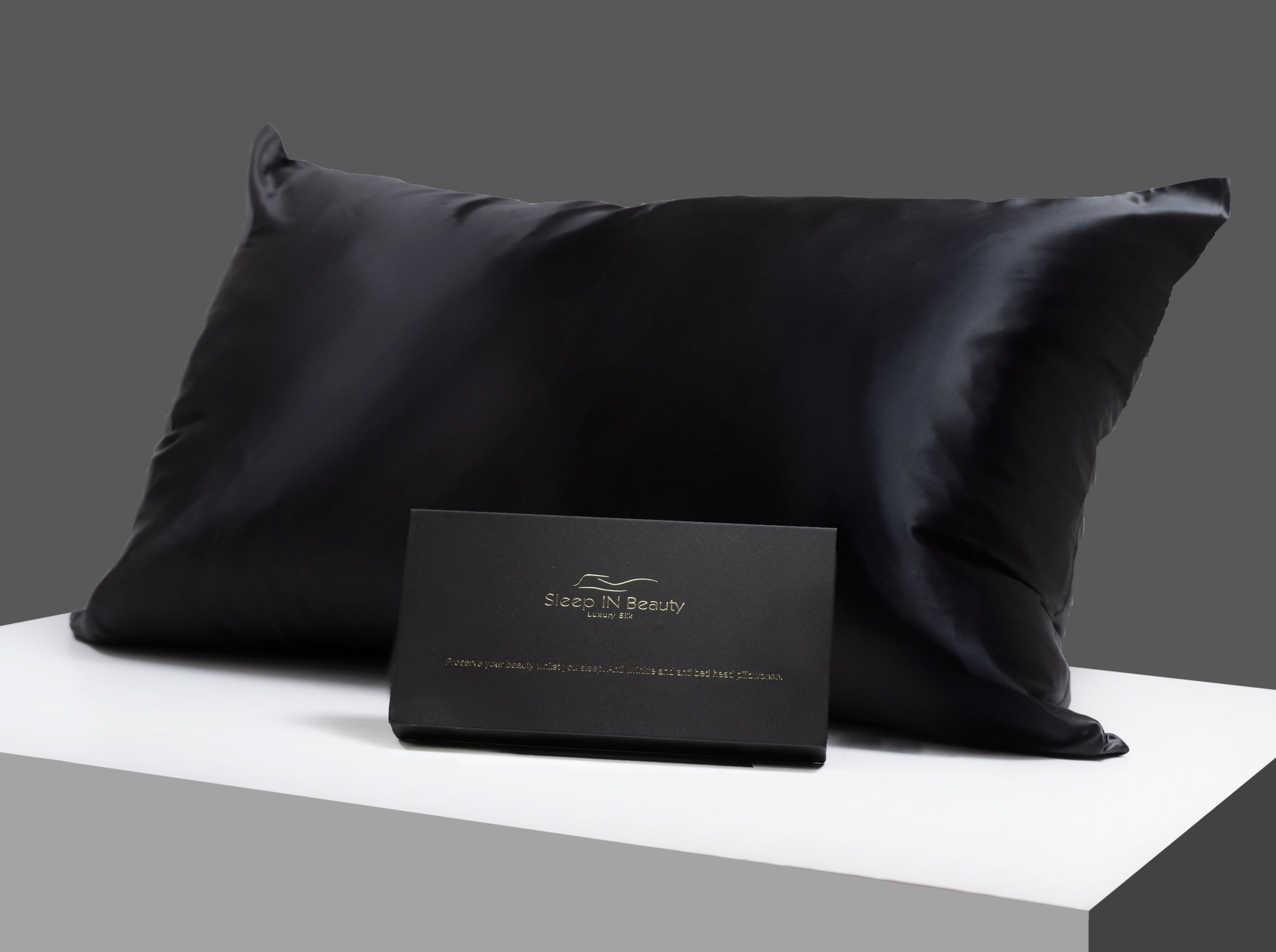 SIB™ Silk Pillowcase in luxurious black silk with hidden zipper, elegantly presented in a gold gift box.