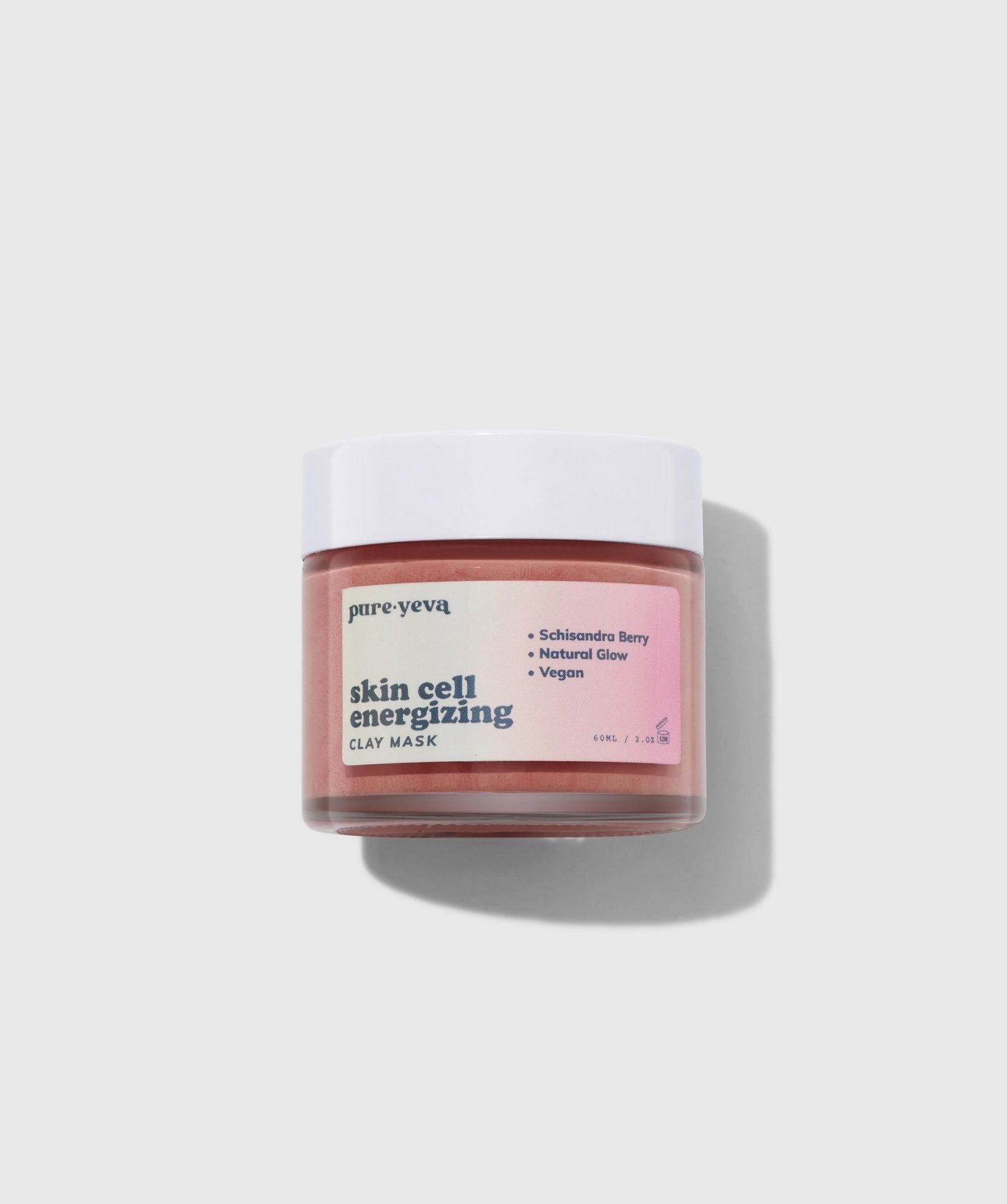 Skin Cell Energizing Clay Mask in a jar with natural ingredients surrounding it, showcasing its rejuvenating properties.