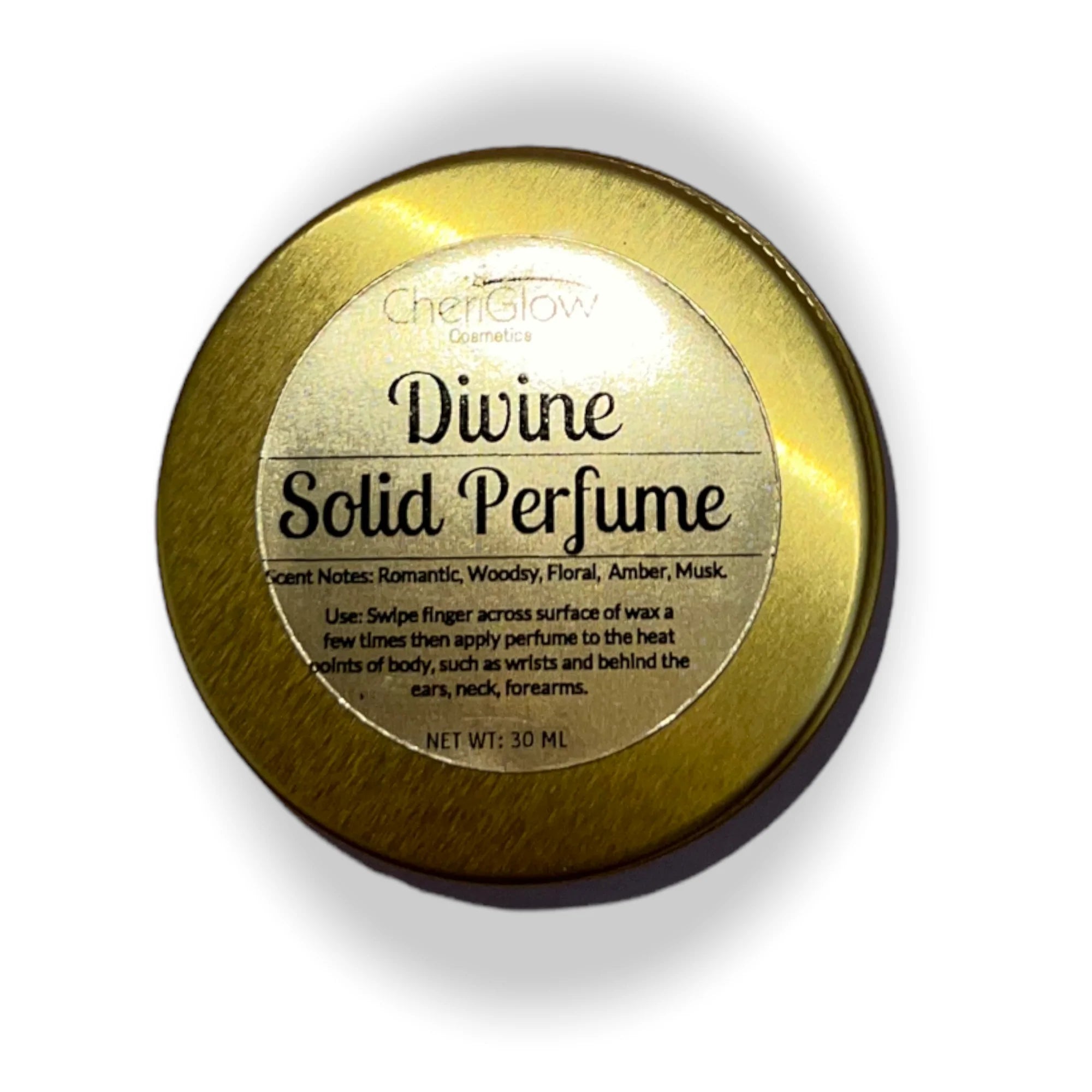 Divine Solid Perfume in a gold metal tin, showcasing its elegant design and compact size for easy portability.