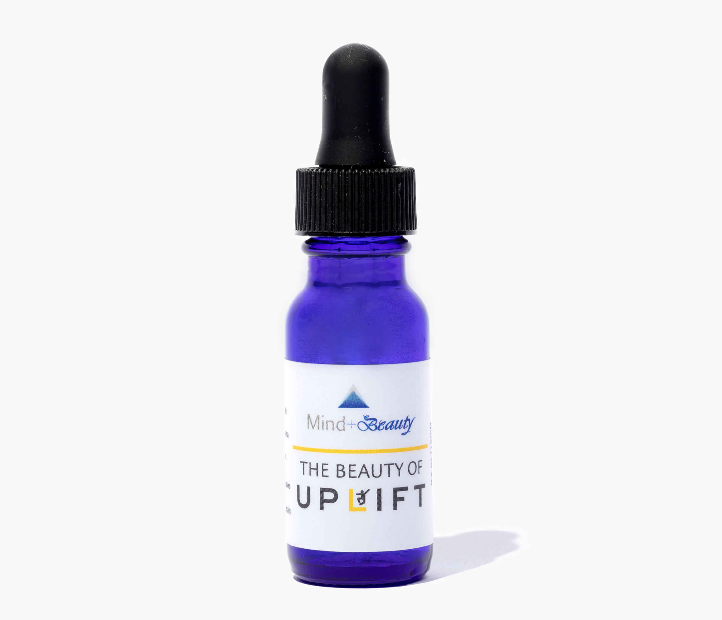 A bottle of The Beauty of Uplift skincare product with a vibrant label, showcasing its natural ingredients and essential oils.