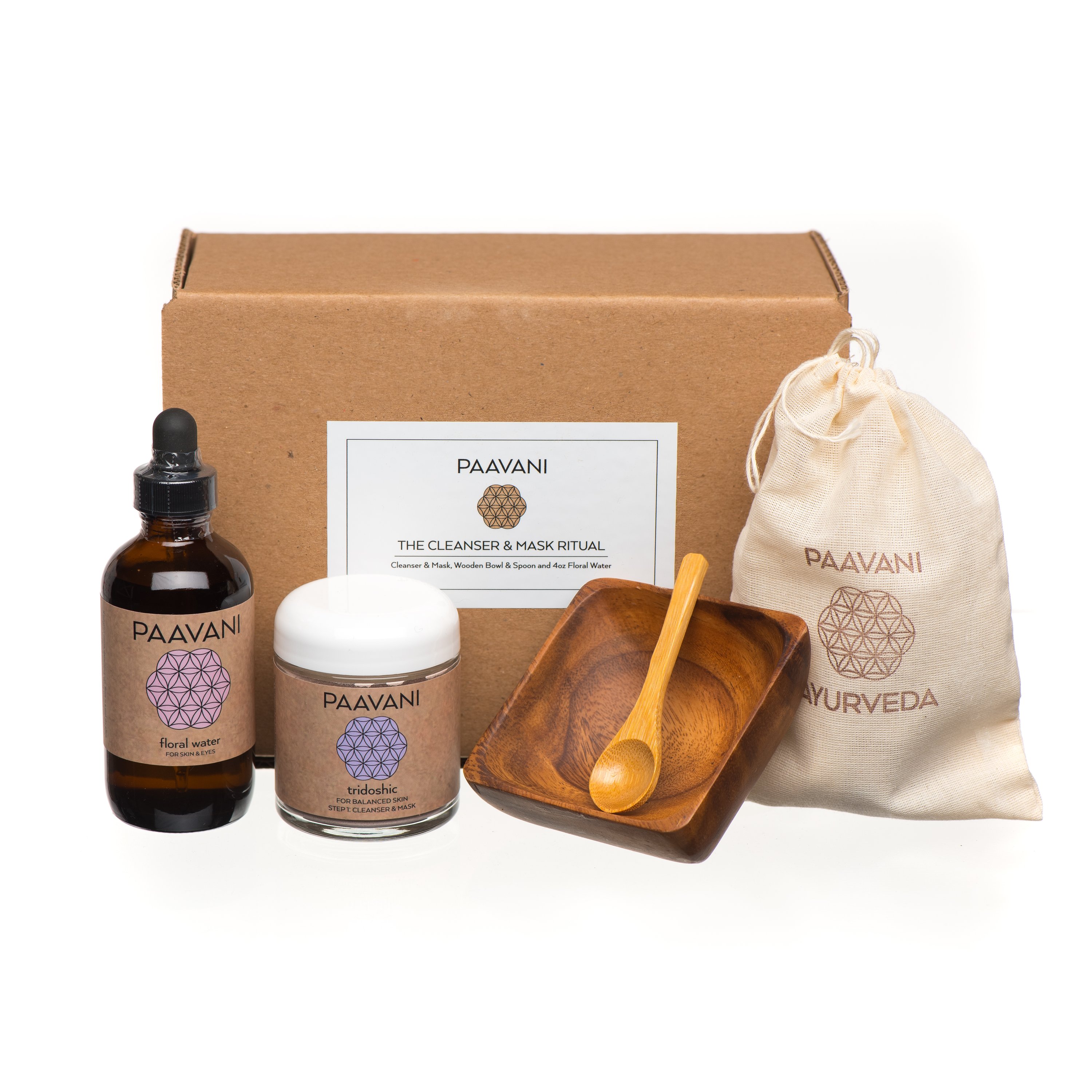 The Cleanser & Mask Ritual set including powdered herbs, floral water, acacia bowl, bamboo spoon, and muslin pouch for skincare.