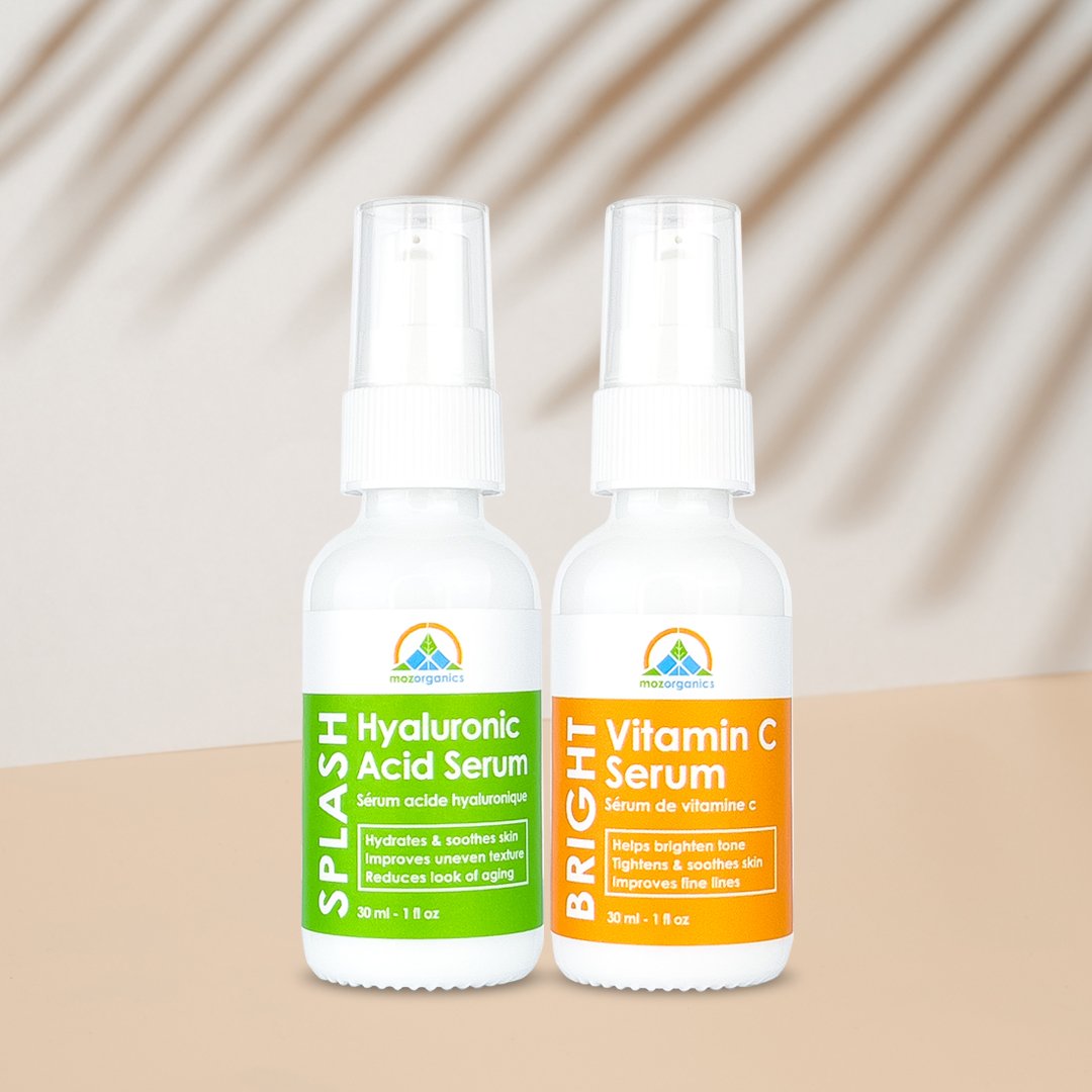 The Serum Set featuring two bottles, one Hyaluronic Acid Serum and one Vitamin C Serum, both with elegant packaging and organic ingredients.