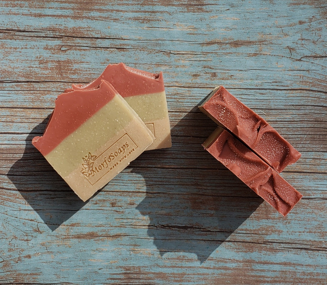 Handmade Triple Clay Soap bar with Sweet Orange essential oil, showcasing its unique colors and textures.