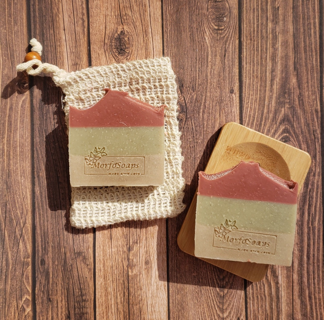 Handmade Triple Clay Soap bar with Sweet Orange essential oil, showcasing its unique colors and textures.