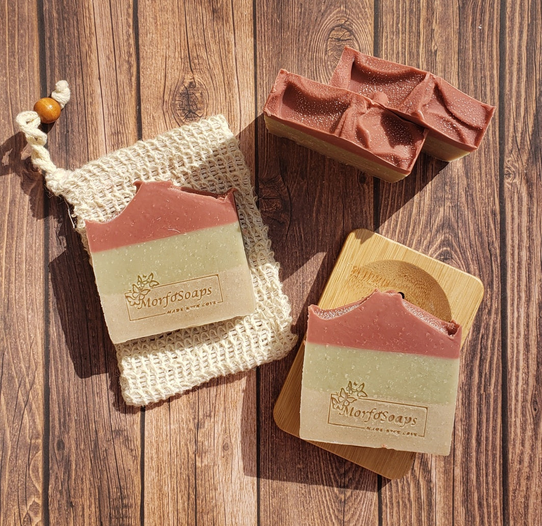 Handmade Triple Clay Soap bar with Sweet Orange essential oil, showcasing its unique colors and textures.