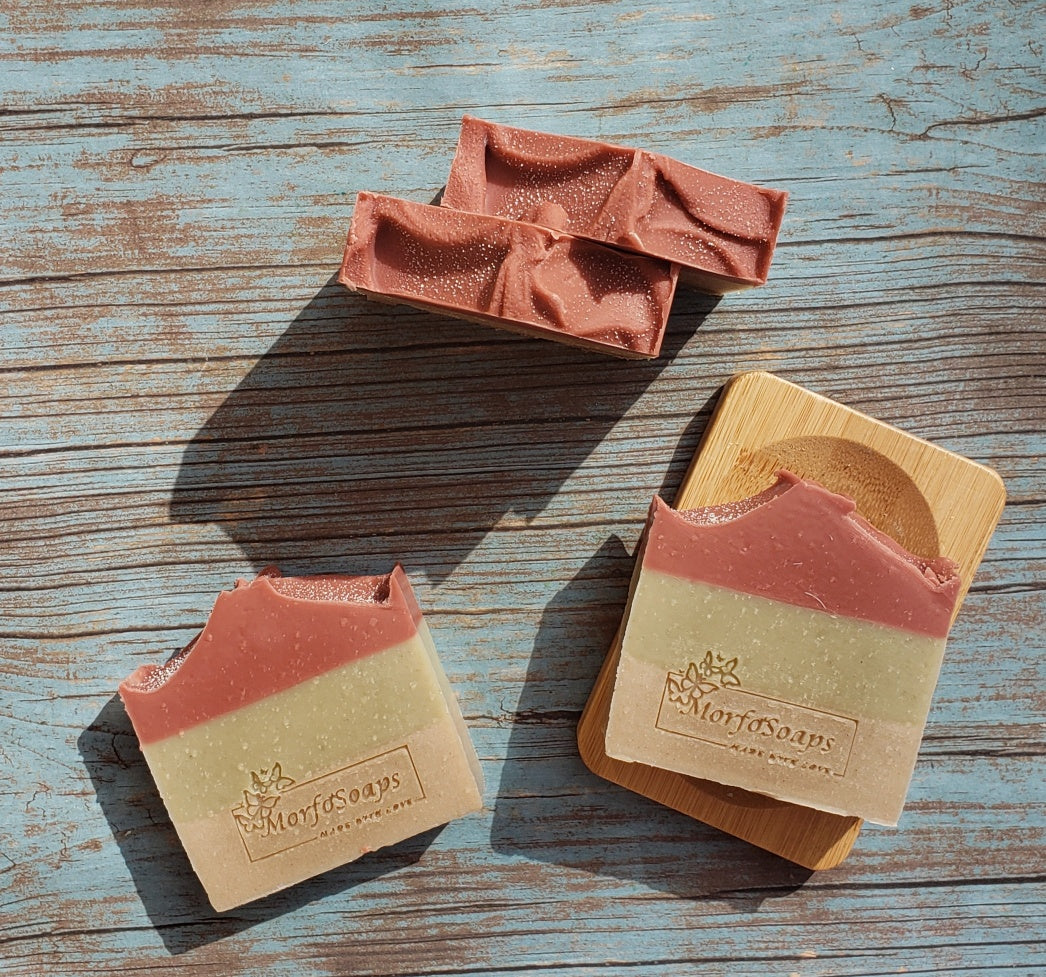 Handmade Triple Clay Soap bar with Sweet Orange essential oil, showcasing its unique colors and textures.