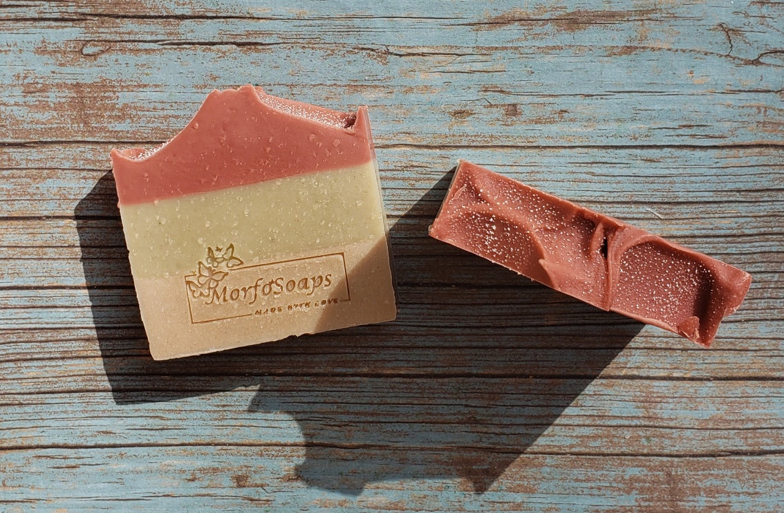 Handmade Triple Clay Soap bar with Sweet Orange essential oil, showcasing its unique colors and textures.