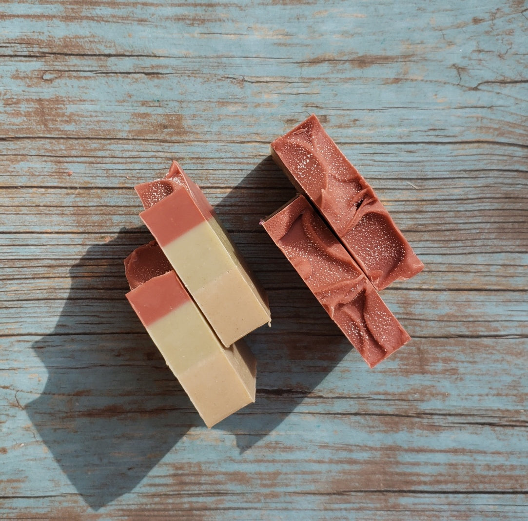 Handmade Triple Clay Soap bar with Sweet Orange essential oil, showcasing its unique colors and textures.