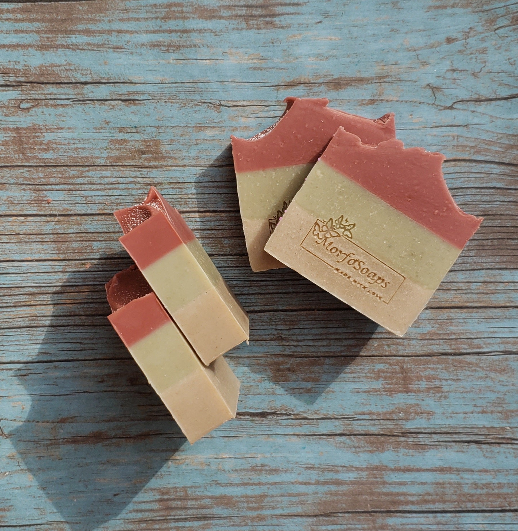 Handmade Triple Clay Soap bar with Sweet Orange essential oil, showcasing its unique colors and textures.