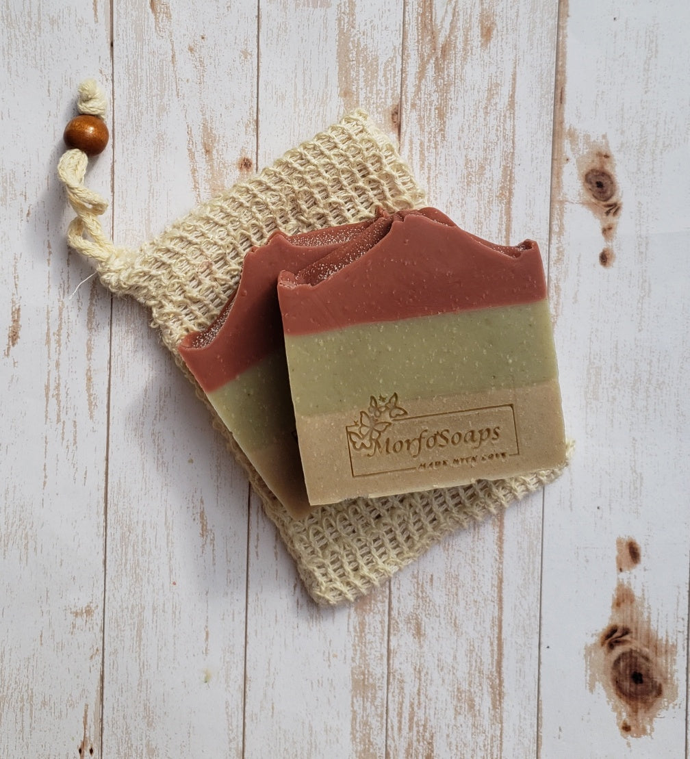 Handmade Triple Clay Soap bar with Sweet Orange essential oil, showcasing its unique colors and textures.