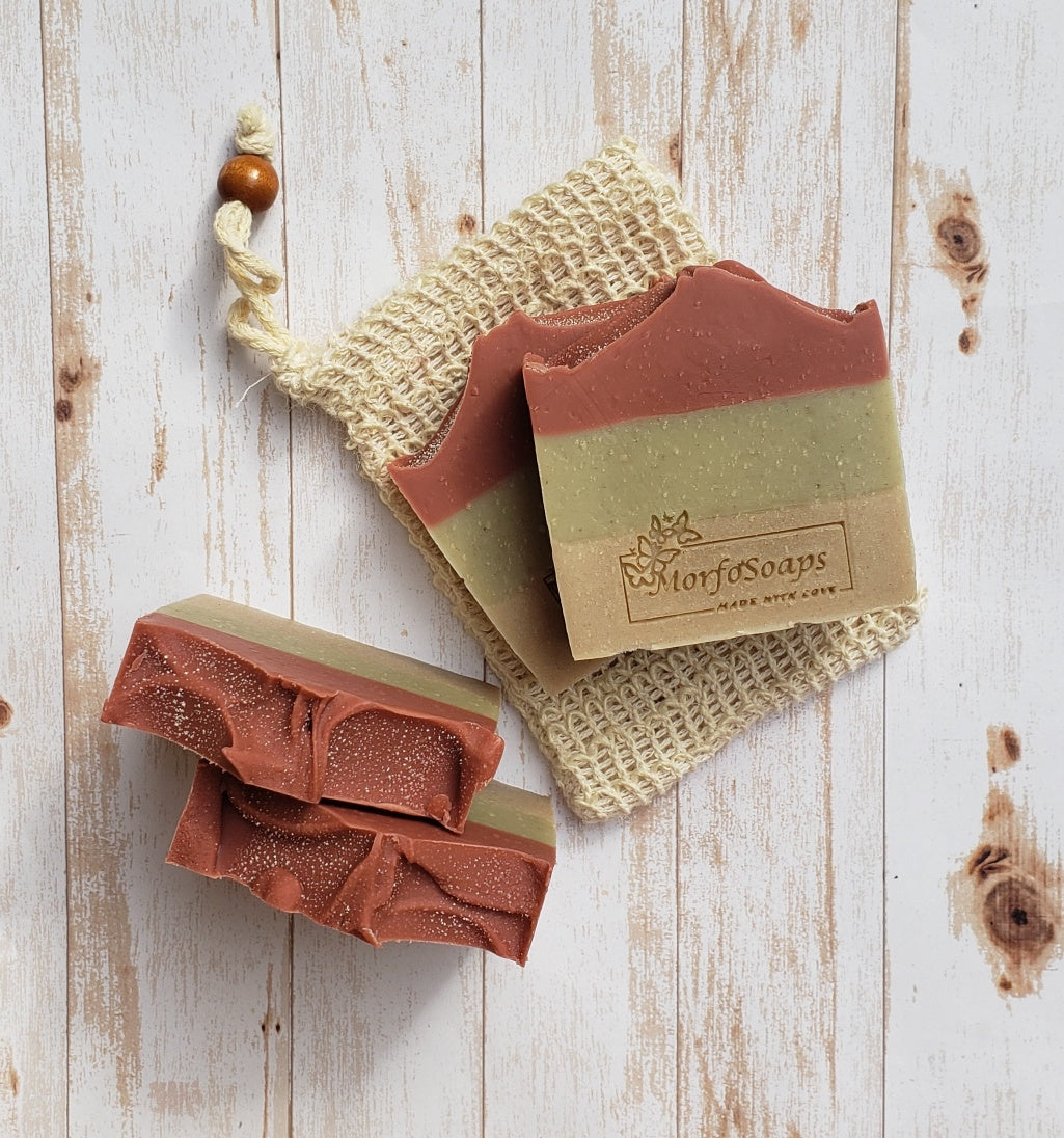 Handmade Triple Clay Soap bar with Sweet Orange essential oil, showcasing its unique colors and textures.