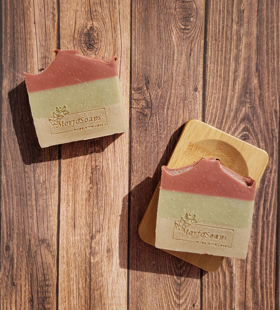 Handmade Triple Clay Soap bar with Sweet Orange essential oil, showcasing its unique colors and textures.