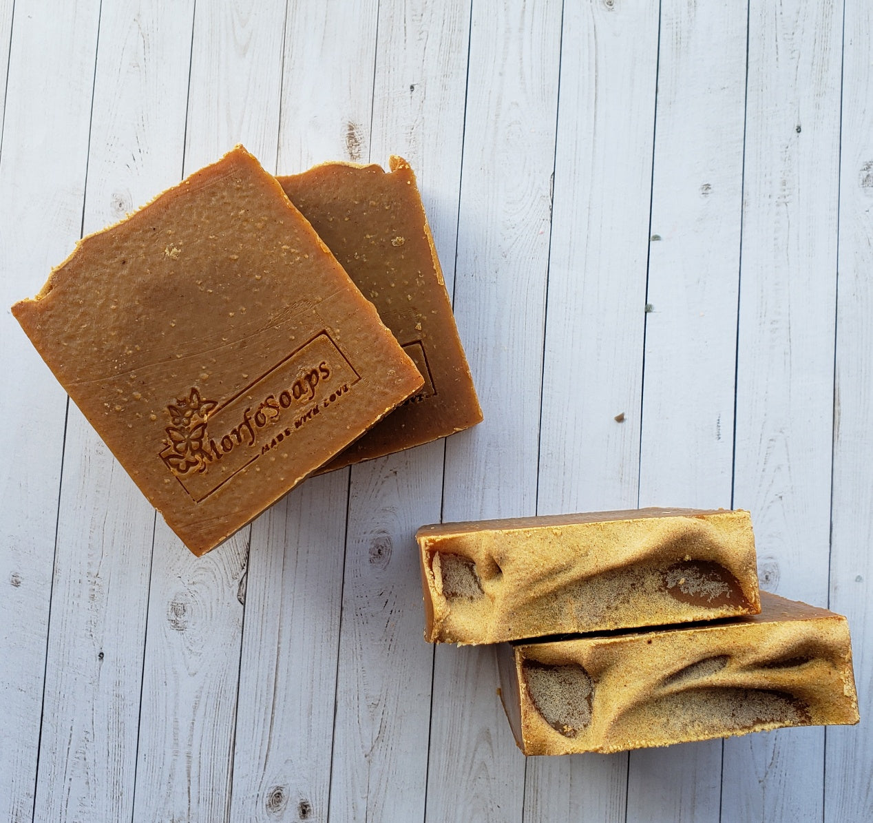 Turmeric Handmade Soap bar with a vibrant yellow color, showcasing its unique texture and natural ingredients, placed on a wooden surface.