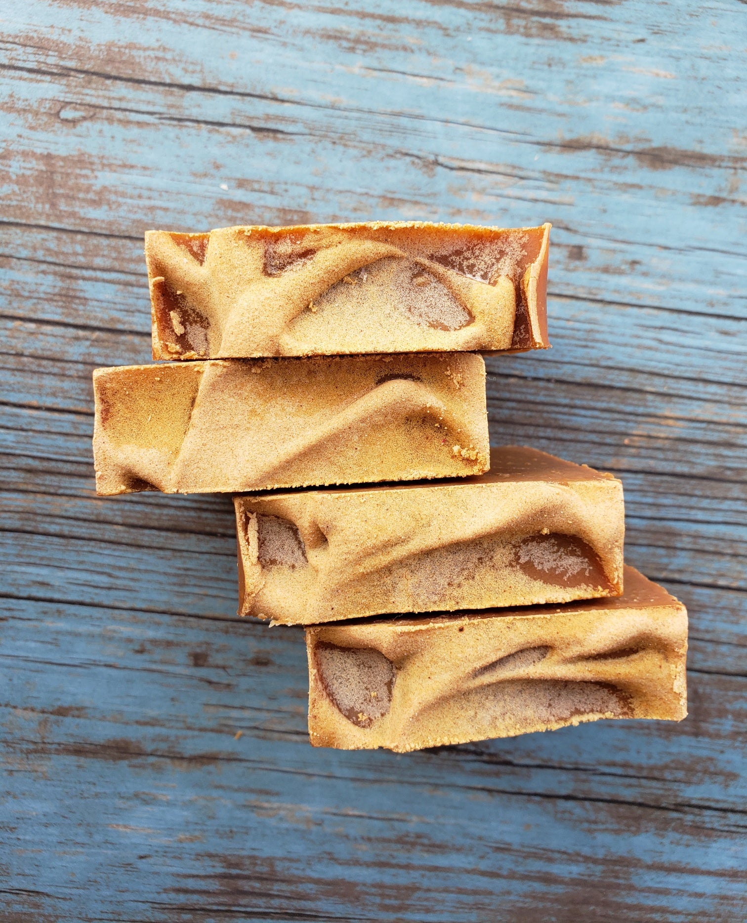 Turmeric Handmade Soap bar with a vibrant yellow color, showcasing its unique texture and natural ingredients, placed on a wooden surface.