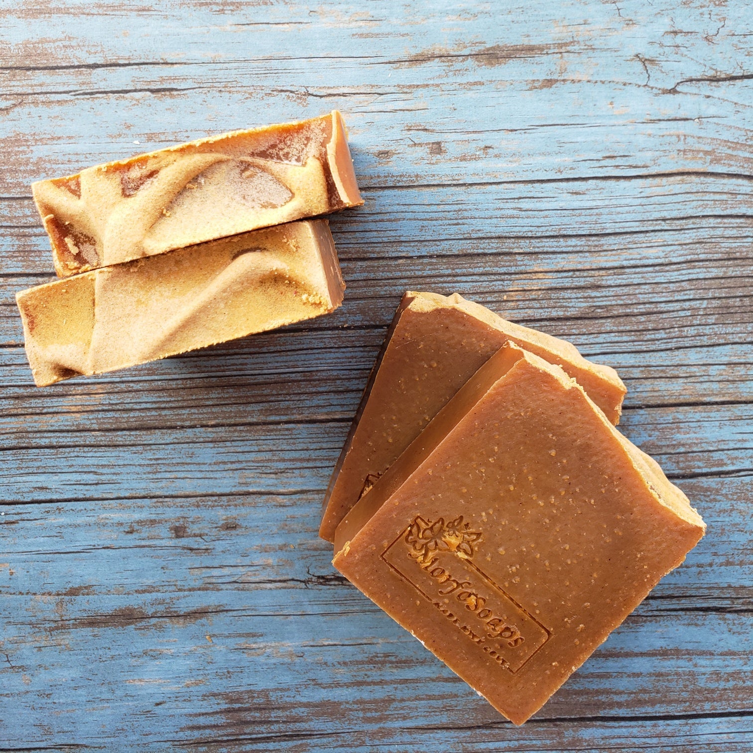 Turmeric Handmade Soap bar with a vibrant yellow color, showcasing its unique texture and natural ingredients, placed on a wooden surface.