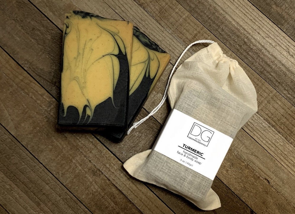 Turmeric Soap & Charcoal Body Soap with organic ingredients, showcasing its creamy texture and rich color.