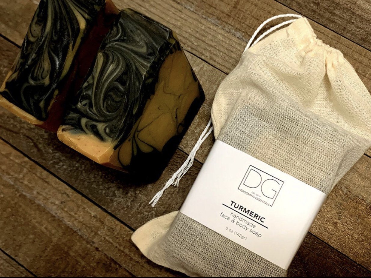 Turmeric Soap & Charcoal Body Soap with organic ingredients, showcasing its creamy texture and rich color.