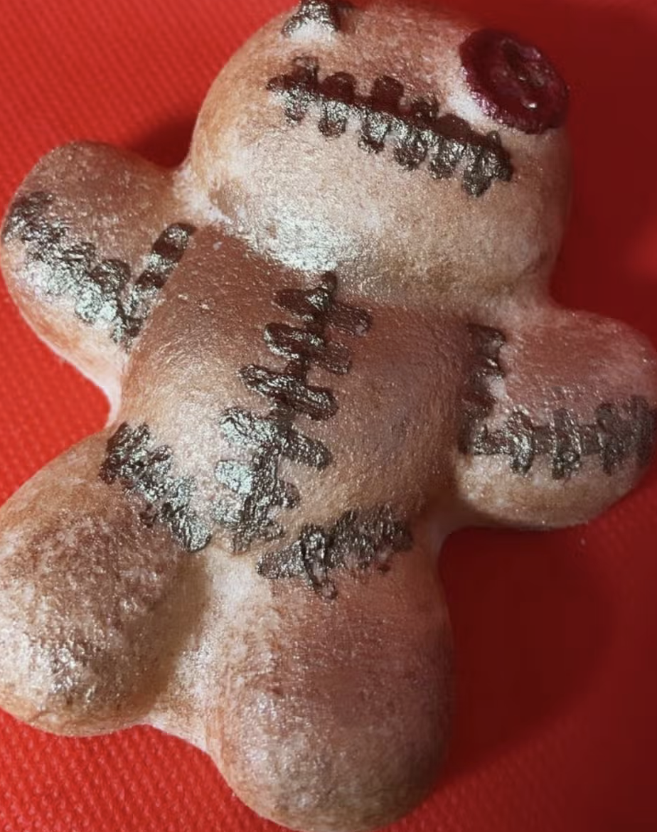 Gingerbread cookie with stitched decorations.