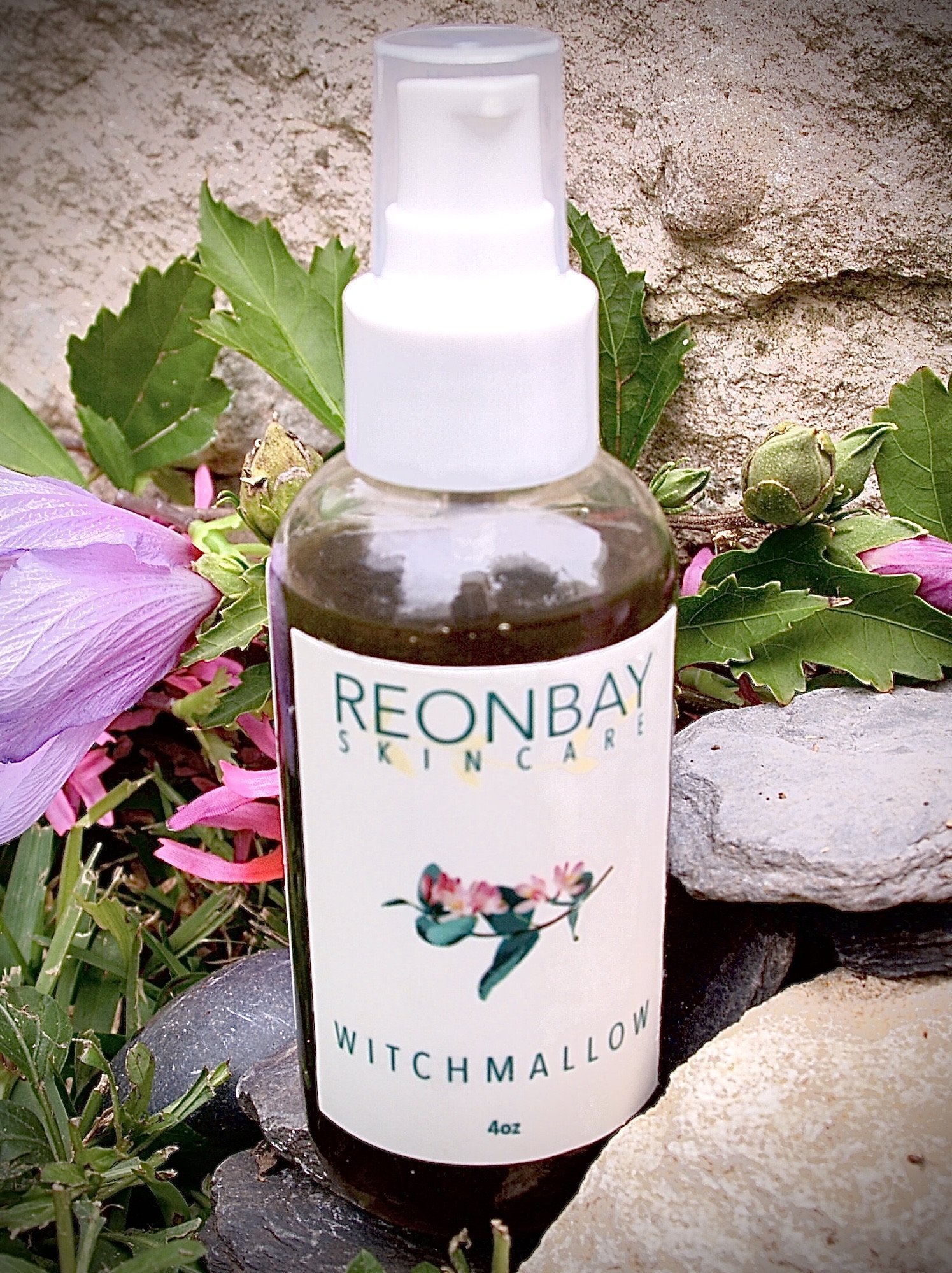 WitchMallow Serum Spray bottle with a botanical design, showcasing its natural ingredients and lightweight formula.