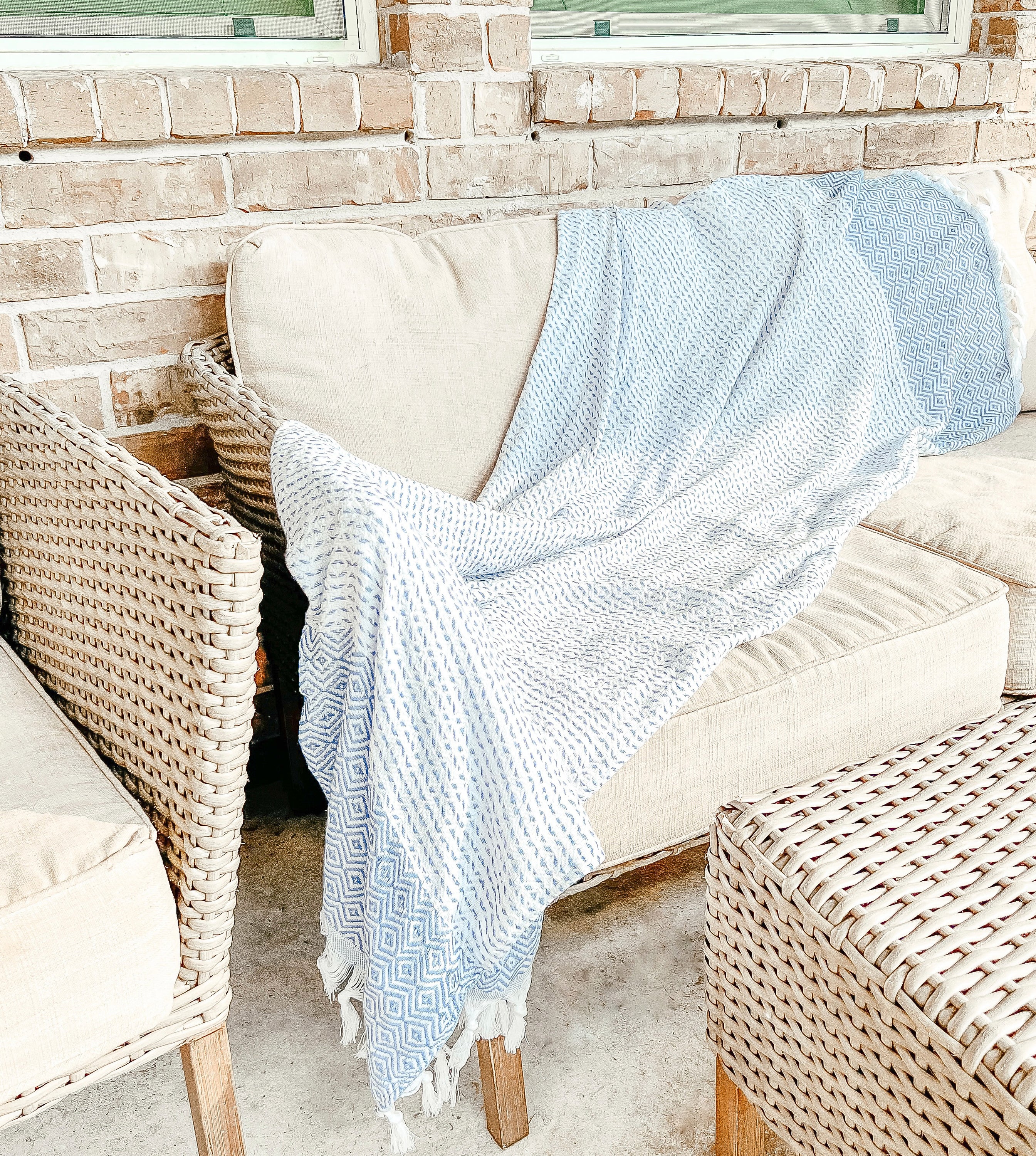 Azra Towel 200GSM in blue and gray with decorative tassels, showcasing its oversized design and soft texture.