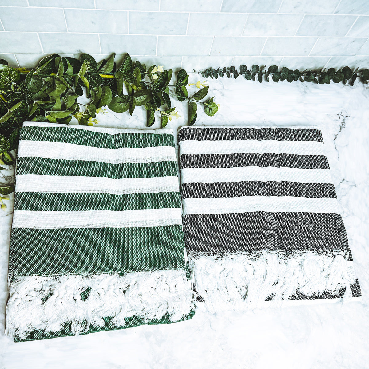 Bold Towel 180GSM made from 100% Turkish cotton, featuring decorative tassels and striped design in charcoal or green.