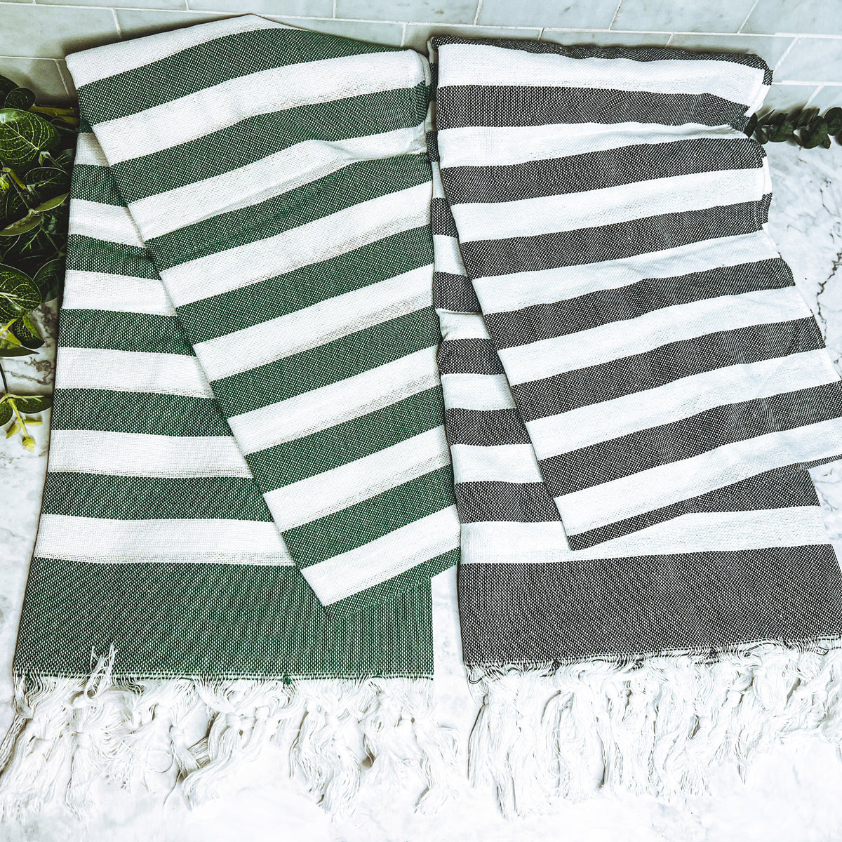 Bold Towel 180GSM made from 100% Turkish cotton, featuring decorative tassels and striped design in charcoal or green.