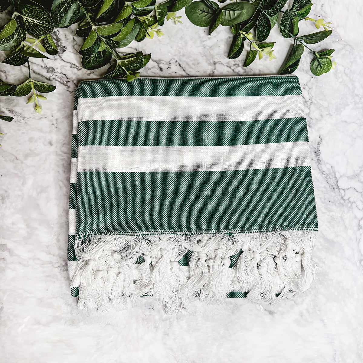 Bold Towel 180GSM made from 100% Turkish cotton, featuring decorative tassels and striped design in charcoal or green.