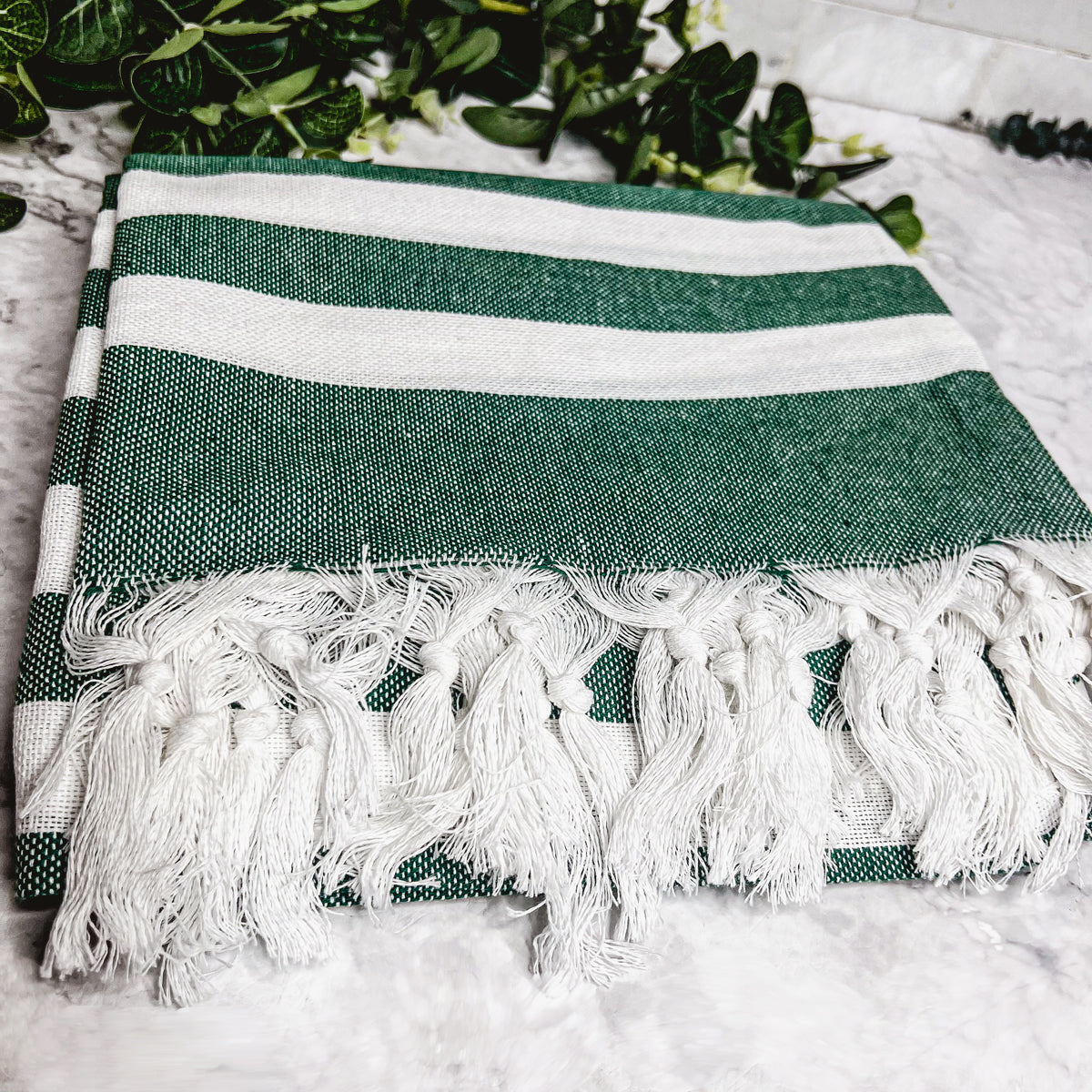 Bold Towel 180GSM made from 100% Turkish cotton, featuring decorative tassels and striped design in charcoal or green.