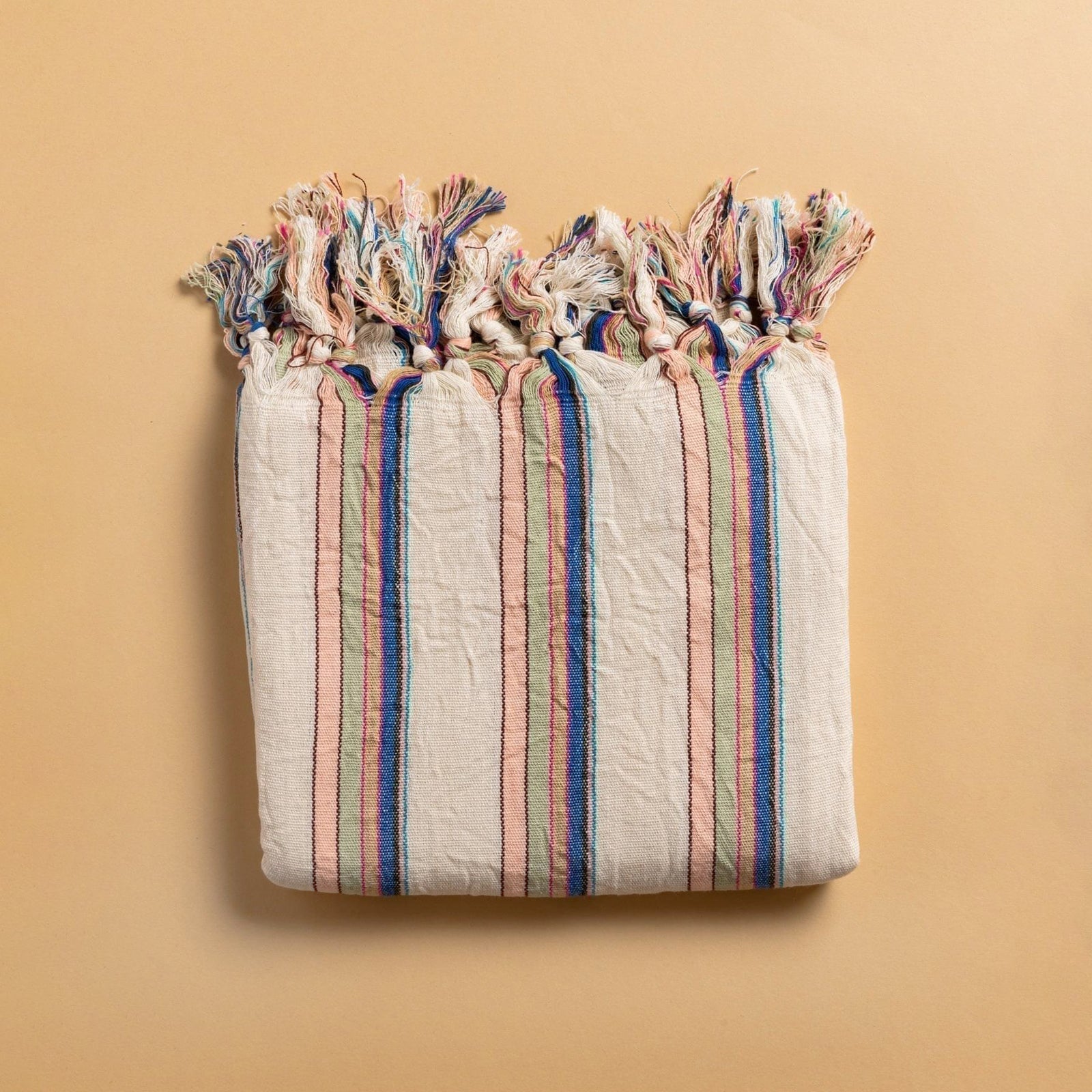 Cicim Handwoven Towel featuring vibrant pink, blue, and green stripes, showcasing artisanal craftsmanship and organic cotton material.