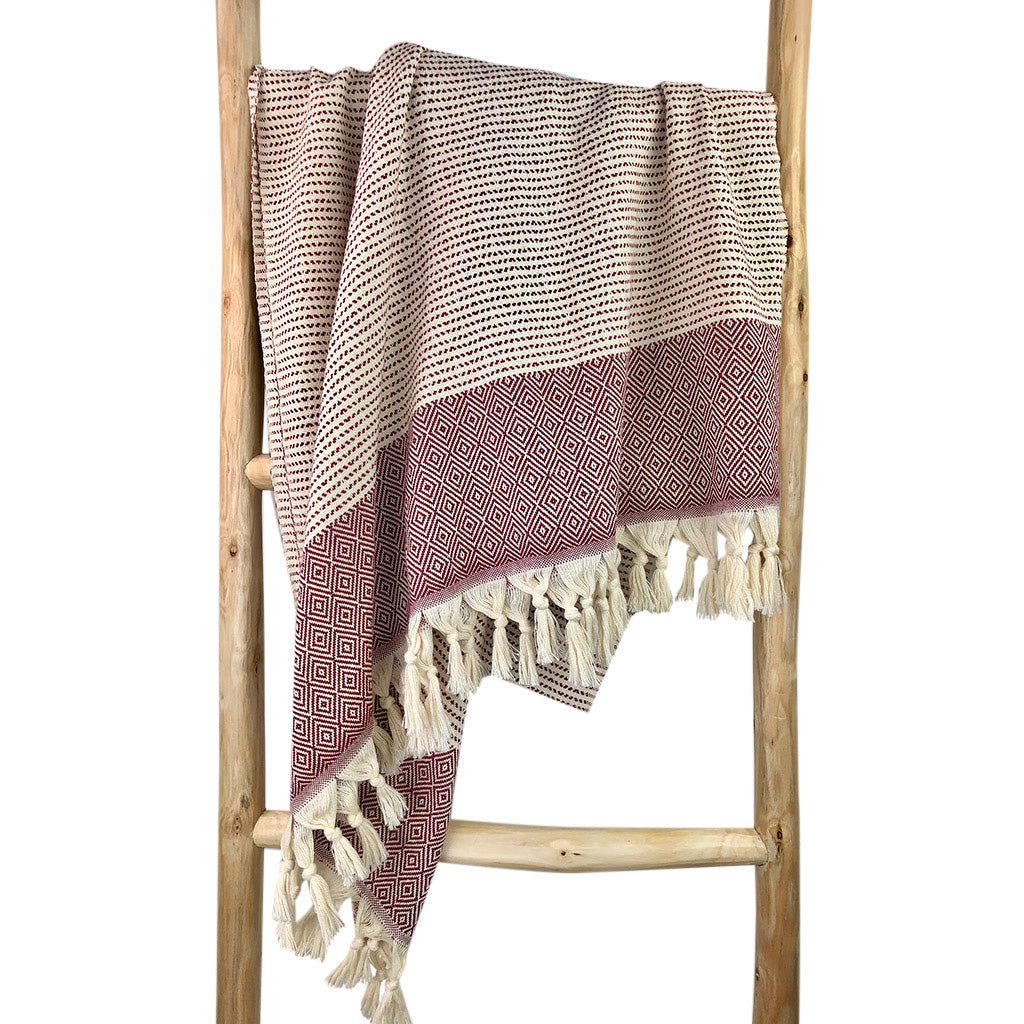 A beautifully crafted Diamond Stripe Turkish Towel showcasing vibrant patterns and tassels, made from 100% Turkish cotton.