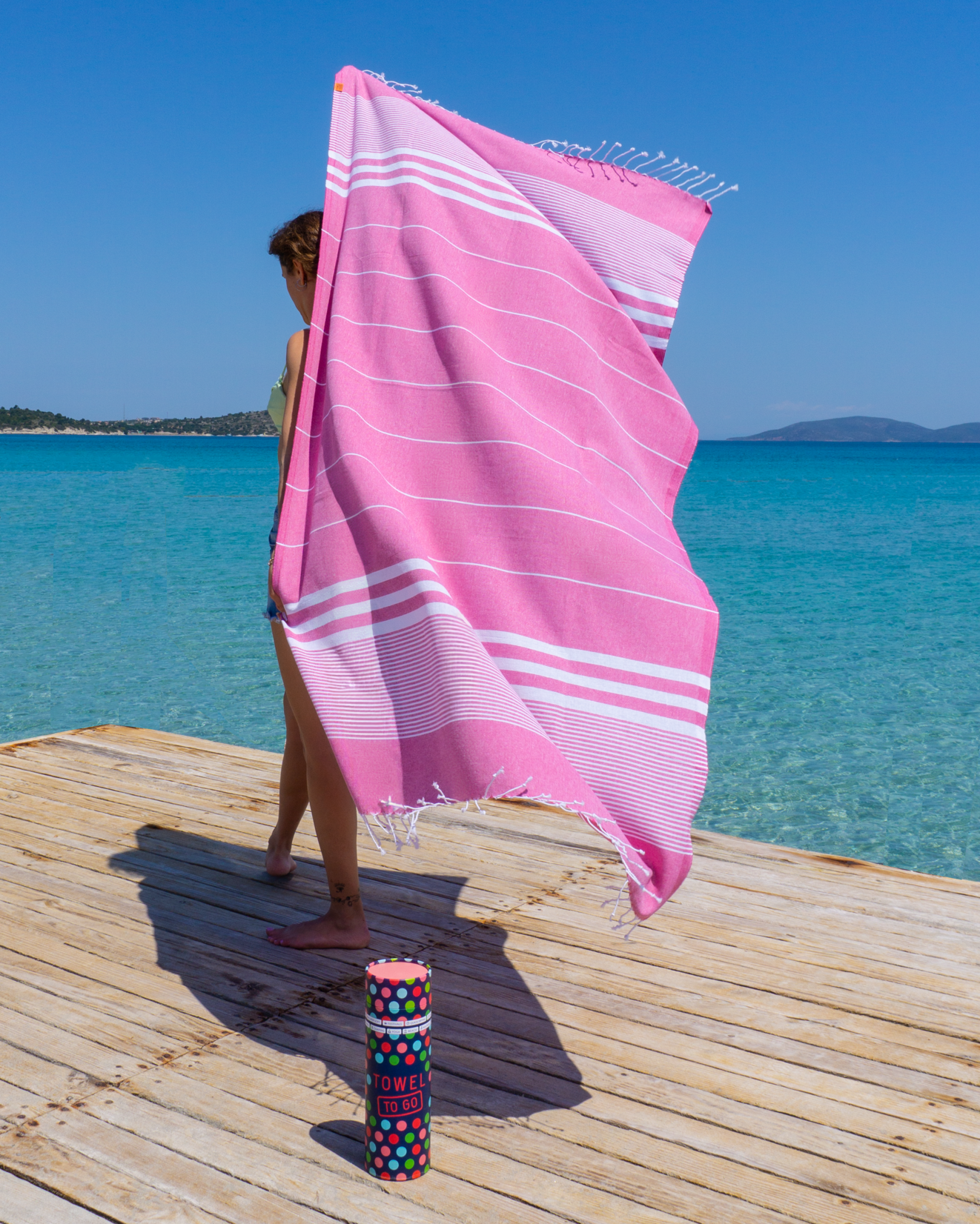 Fuchsia Malibu Hammam Towel displayed in a recycled gift box, showcasing its vibrant color and eco-friendly packaging.