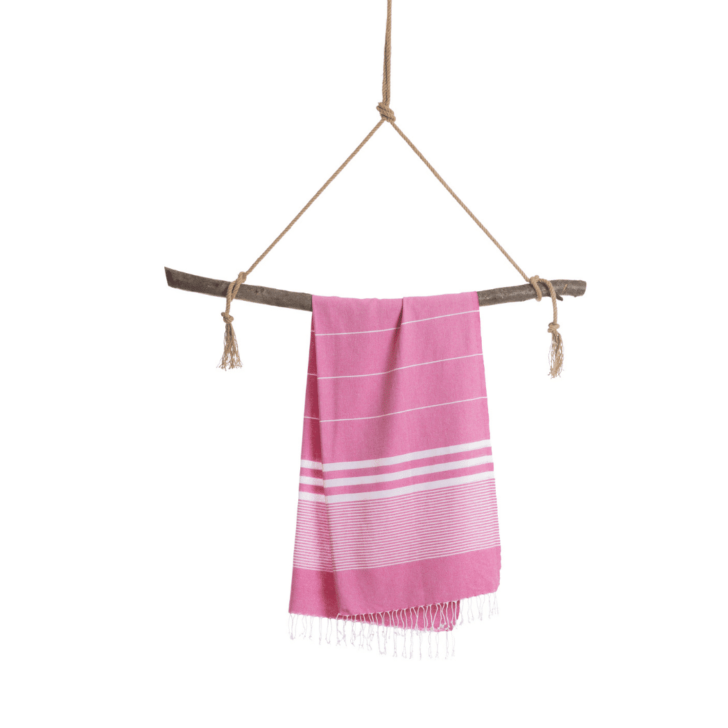 Fuchsia Malibu Hammam Towel displayed in a recycled gift box, showcasing its vibrant color and eco-friendly packaging.