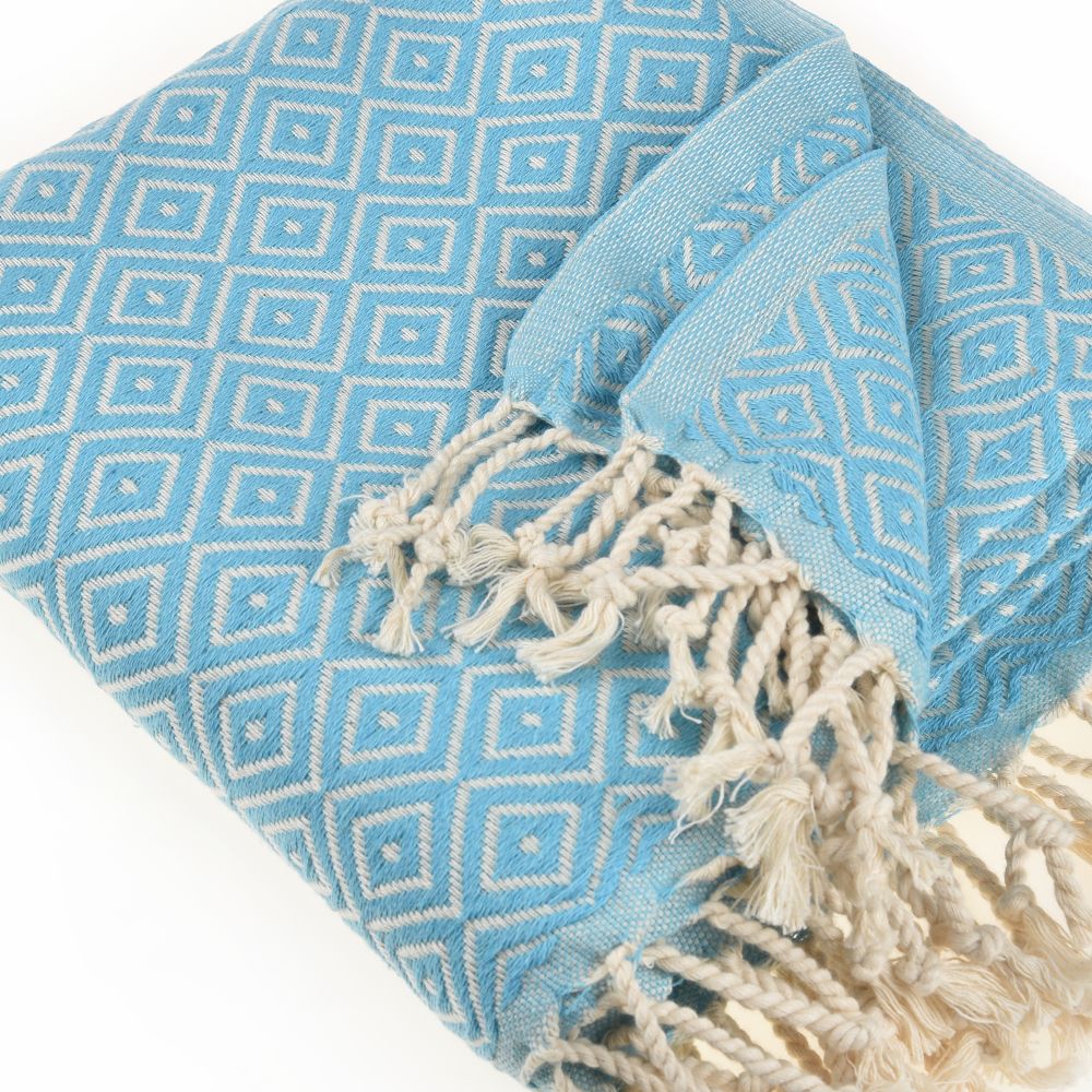 Malta Beach Towel displayed on a sandy beach, showcasing its vibrant colors and traditional woven design, perfect for beach and outdoor activities.