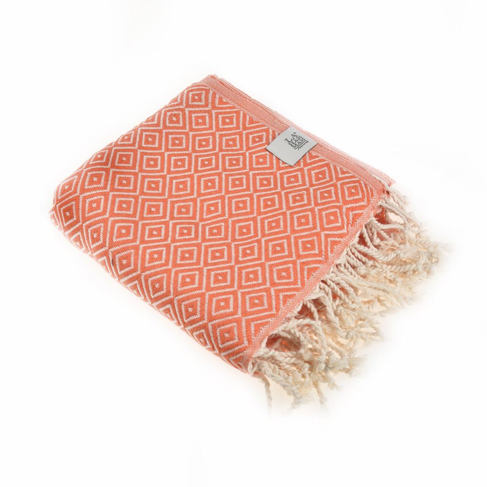 Malta Beach Towel displayed on a sandy beach, showcasing its vibrant colors and traditional woven design, perfect for beach and outdoor activities.