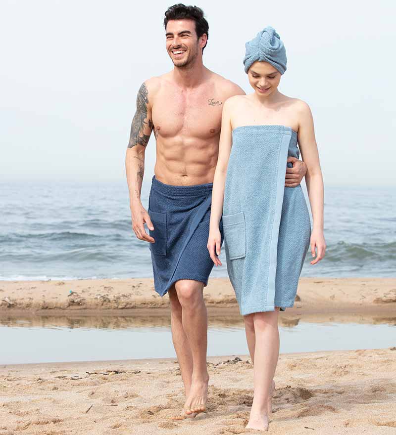 Men's Turkish Cotton Towel Wrap in various colors, showcasing its adjustable velcro closure and pocket feature.