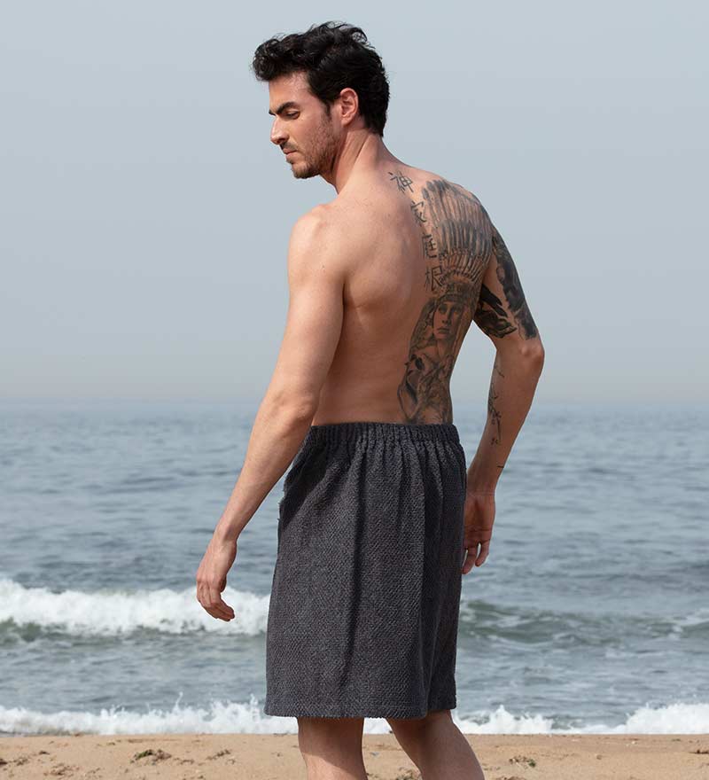 Men's Turkish Cotton Towel Wrap in various colors, showcasing its adjustable velcro closure and pocket feature.