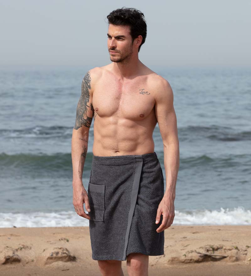 Men's Turkish Cotton Towel Wrap in various colors, showcasing its adjustable velcro closure and pocket feature.