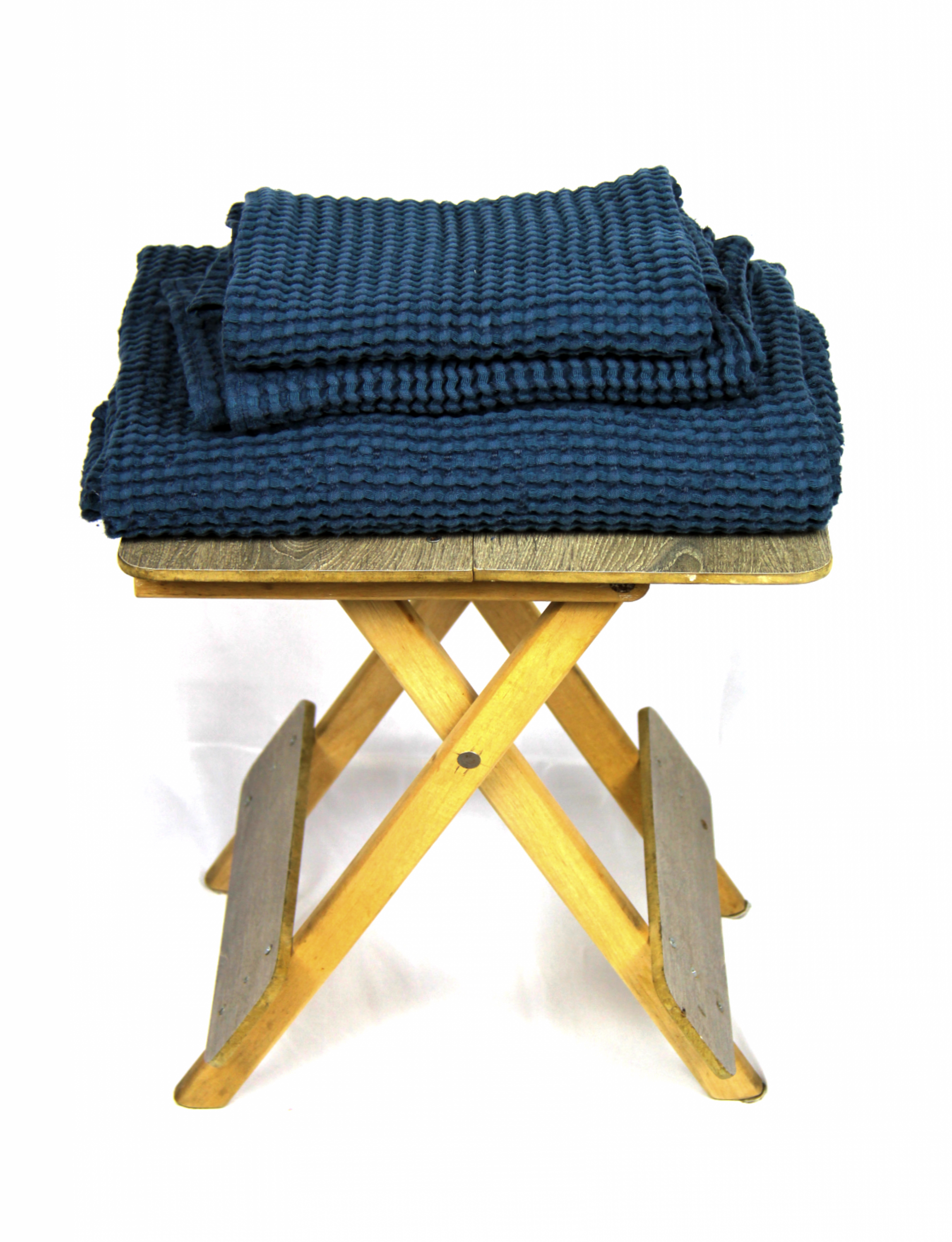 Luxurious navy blue linen waffle towel with a unique texture, showcasing its softness and absorbency.