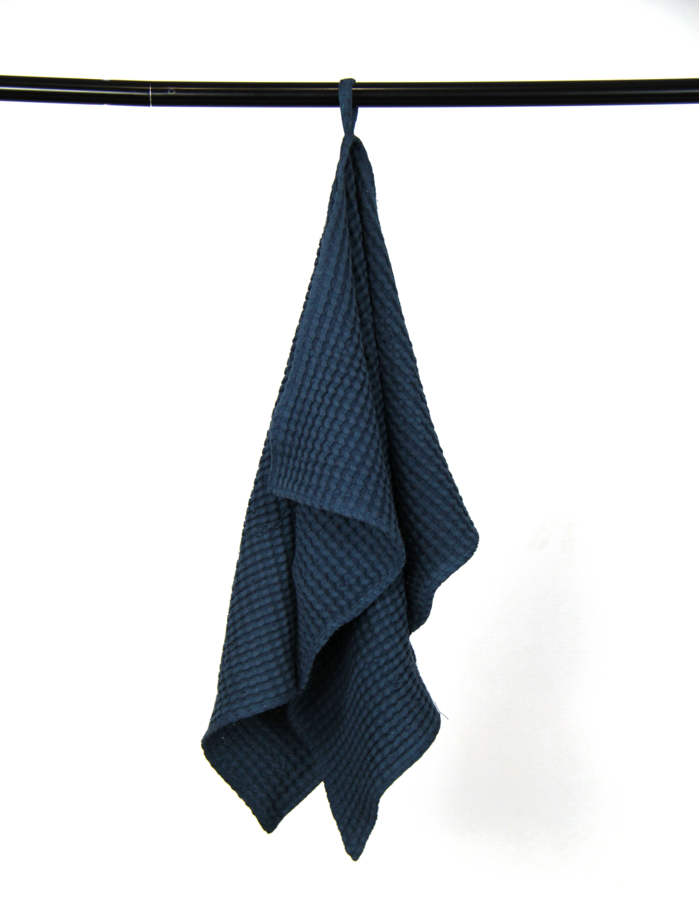 Luxurious navy blue linen waffle towel with a unique texture, showcasing its softness and absorbency.