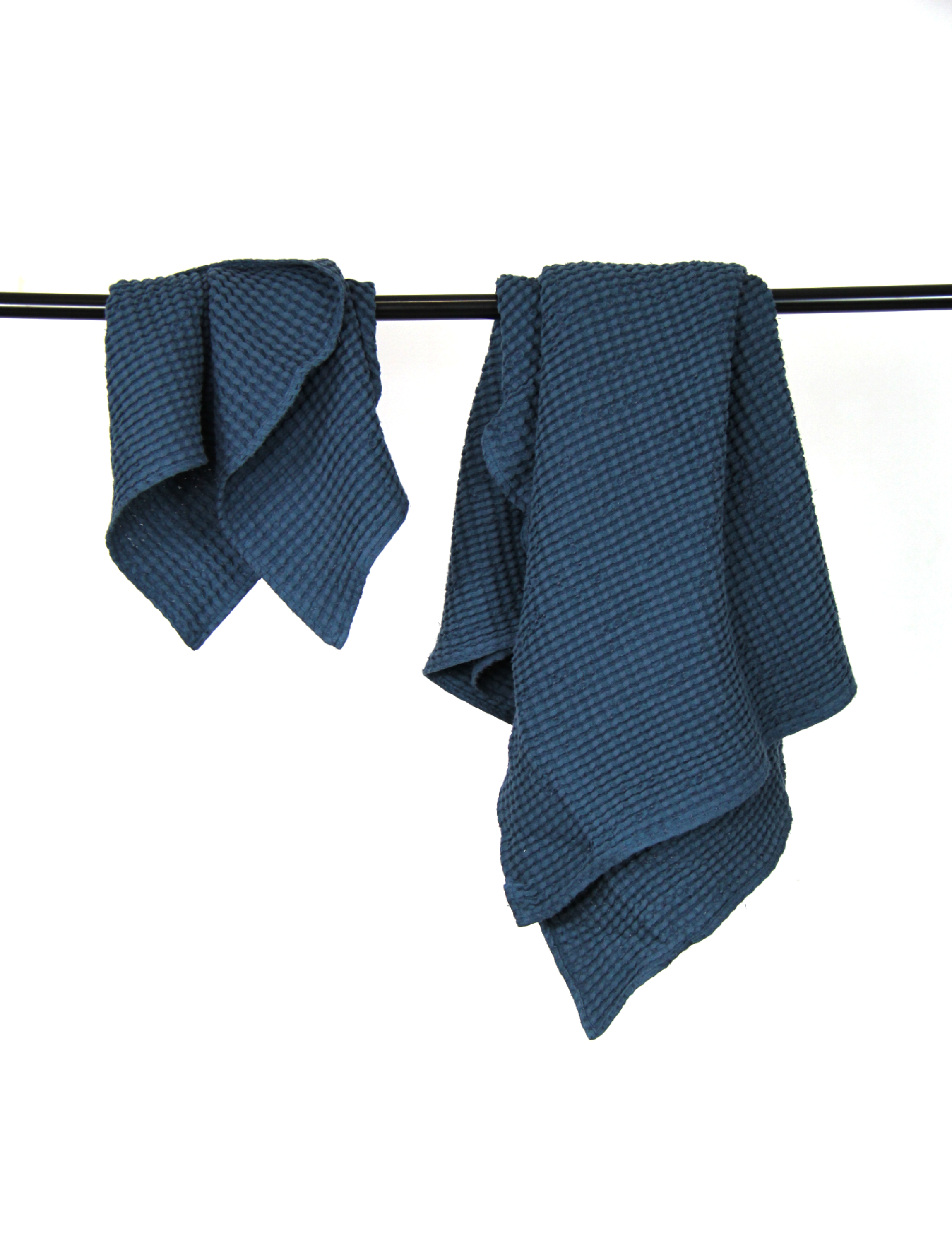 Luxurious navy blue linen waffle towel with a unique texture, showcasing its softness and absorbency.