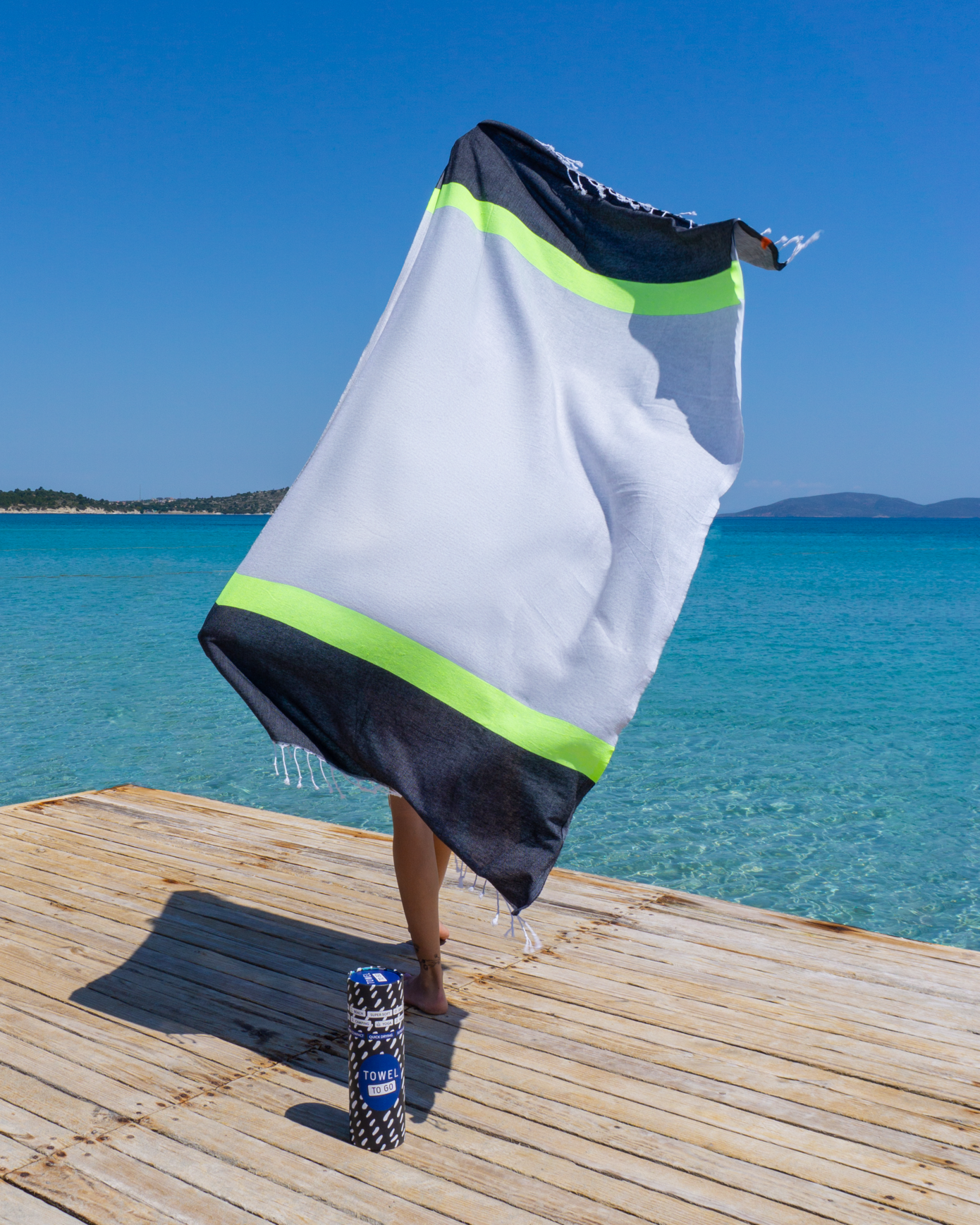 Neon Beach Towel in grey and black with neon stripe, displayed in a recycled gift box, showcasing eco-friendly design.